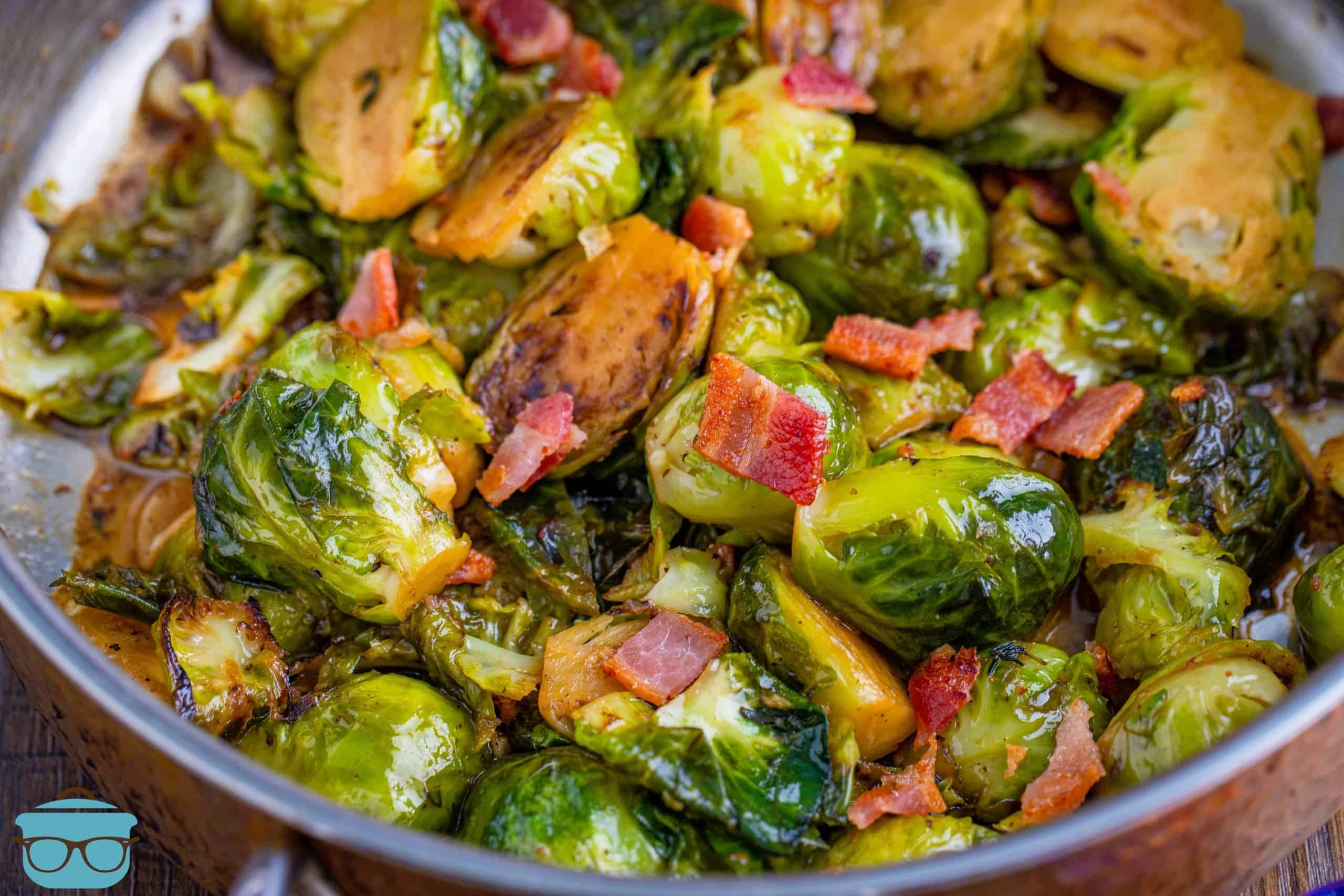 Stovetop Brussel Sprouts with Bacon shown in a silver frying pan.