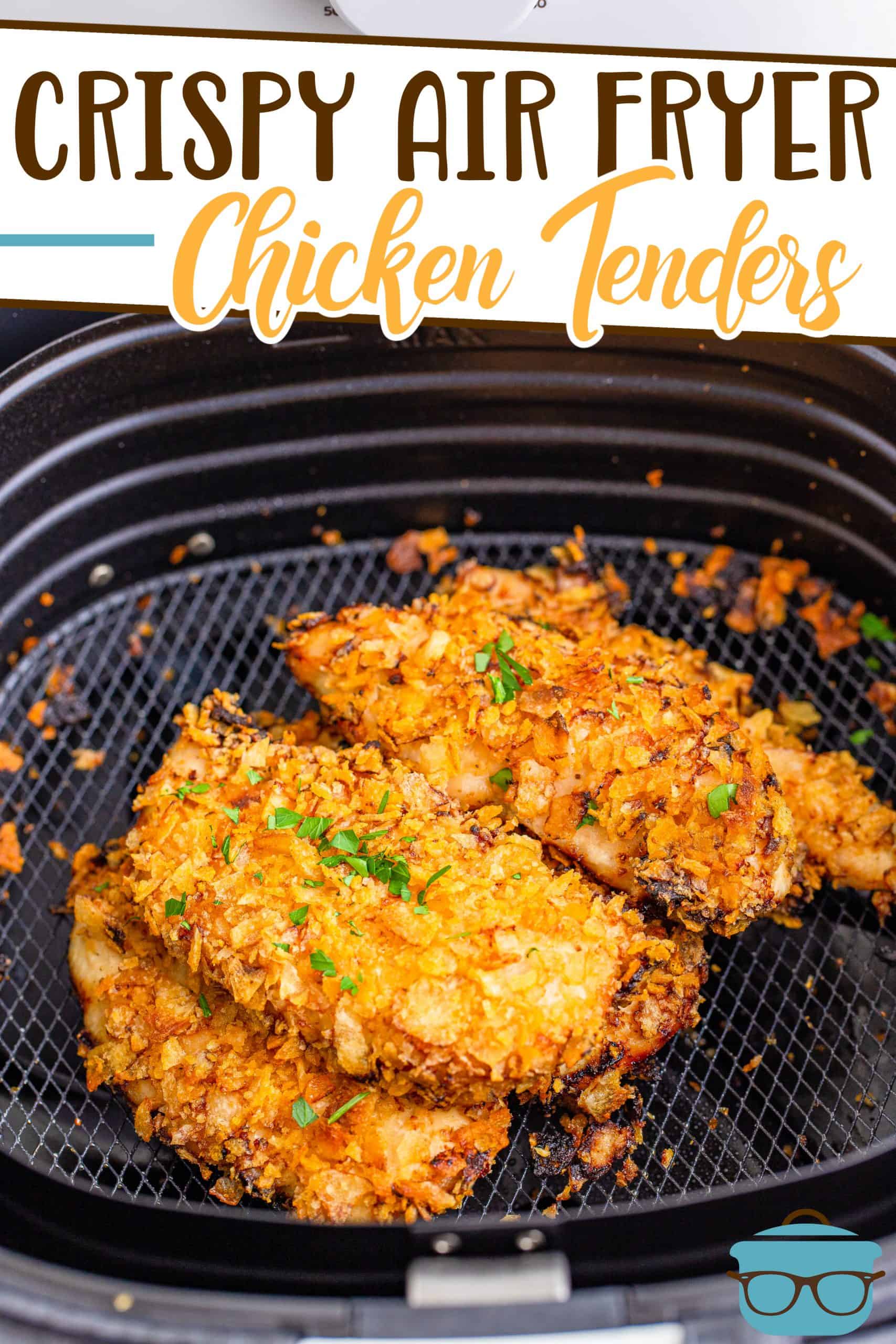 Crispy Air Fryer Chicken Tender recipe from The Country Cook, tenders shown in a black air fryer basket and topped with chopped parsley.