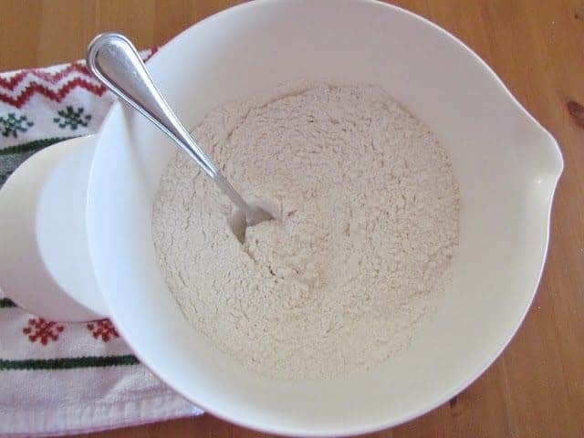 fork inside flour mixture in a white bowl