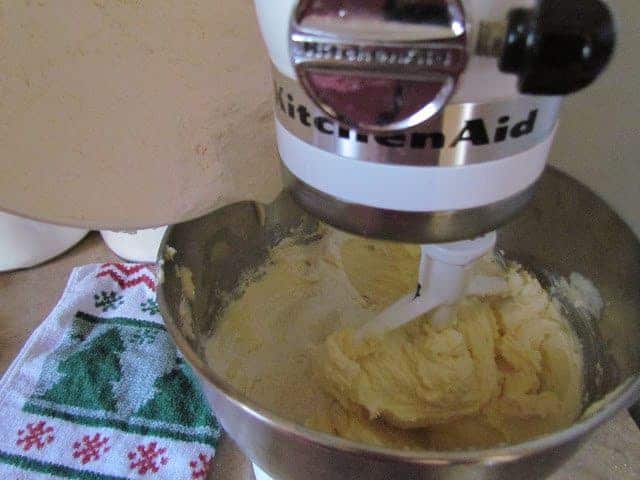 slowly adding flour mixture from white mixing bowl to shortening mixture in steel bowl of stand mixer