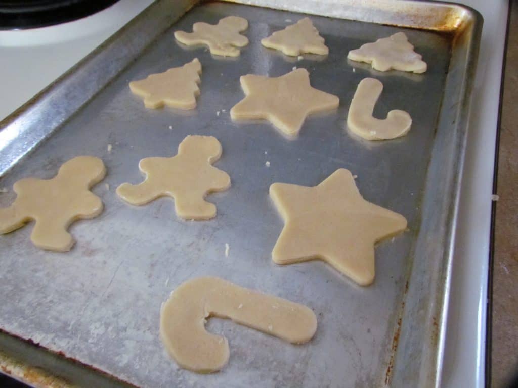 cut out sugar cookie Christmas sheets shown on a baking sheet
