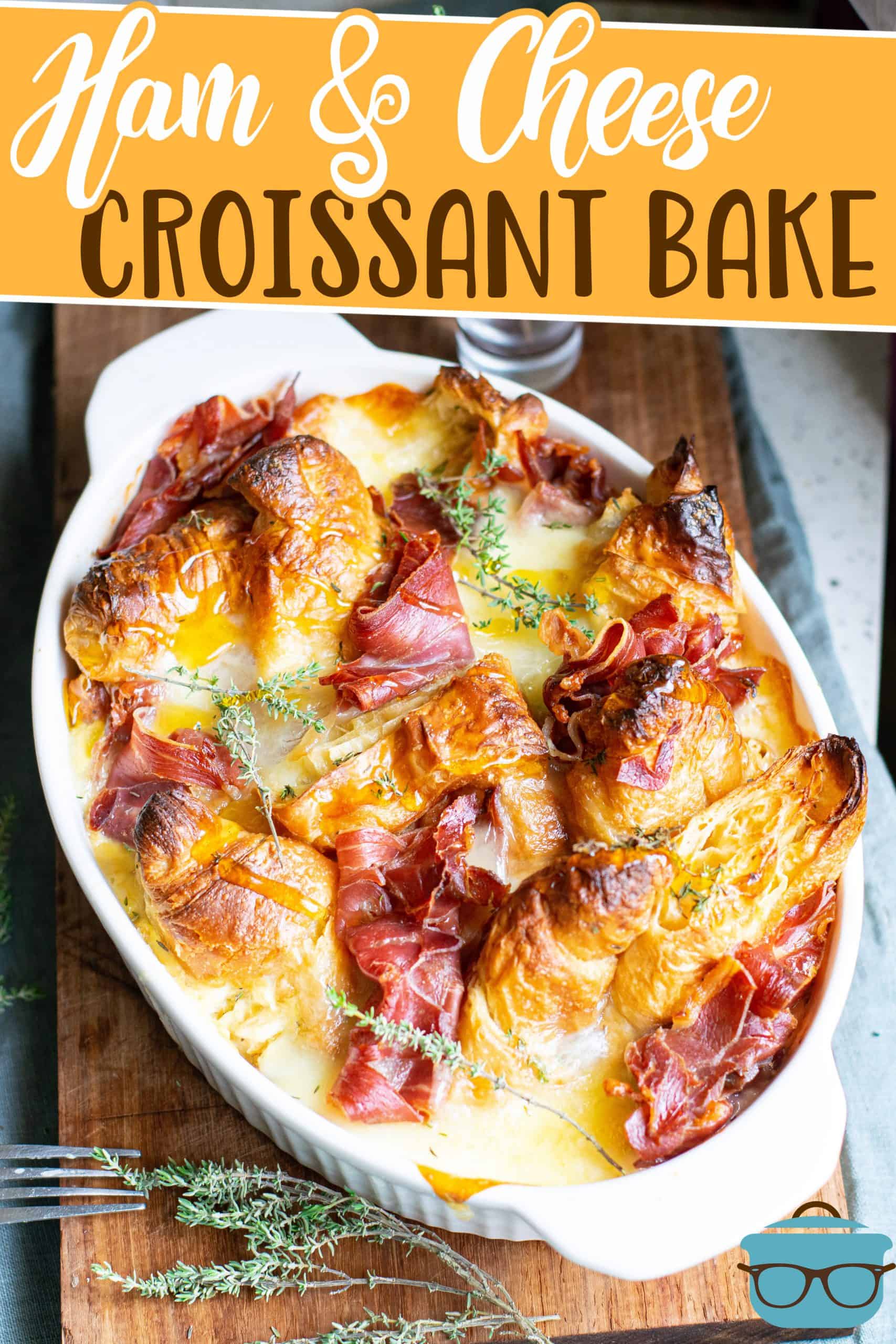 Ham and Cheese Croissant Bake recipe from The Country Cook, shown in a white oval baking dish with a sprig of thyme off to the side of the dish.