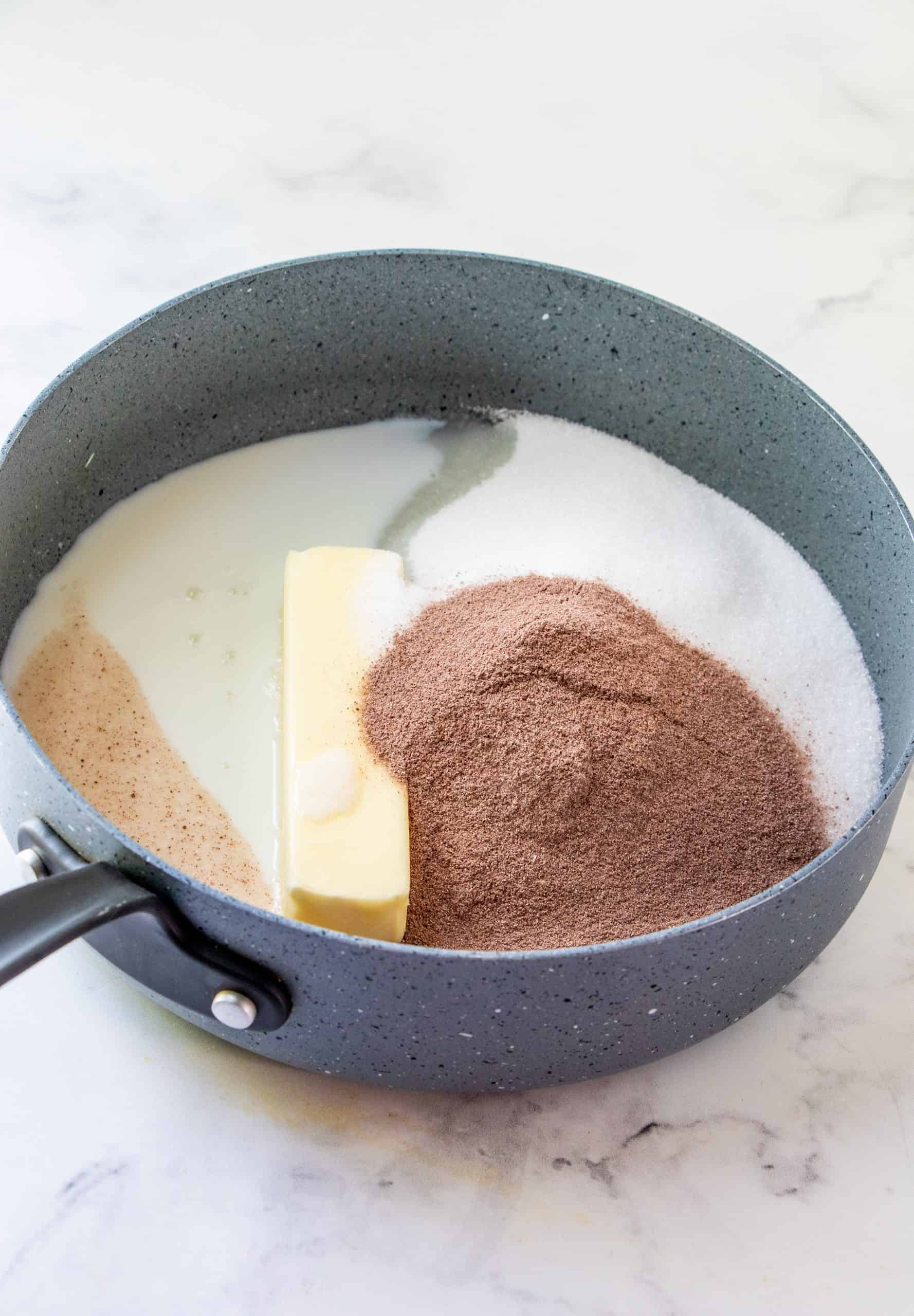a stick of butter, sugar, milk and hot chocolate powder mix in a large pan.