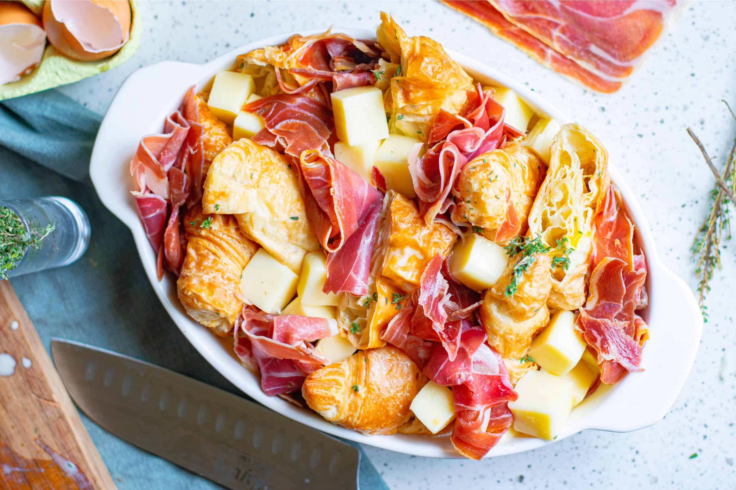 cubed mozzarella and thin slices of prosciutto packed in between croissant pieces.