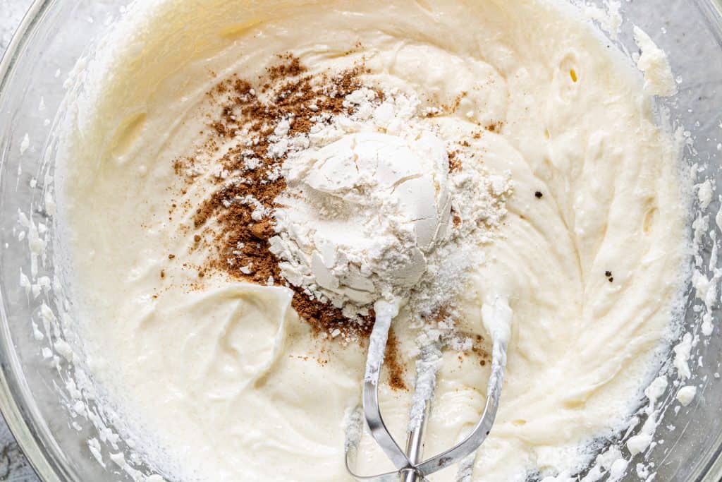 pumpkin pie spice, flour and salt added to butter and cream cheese mixture in a large, clear bowl
