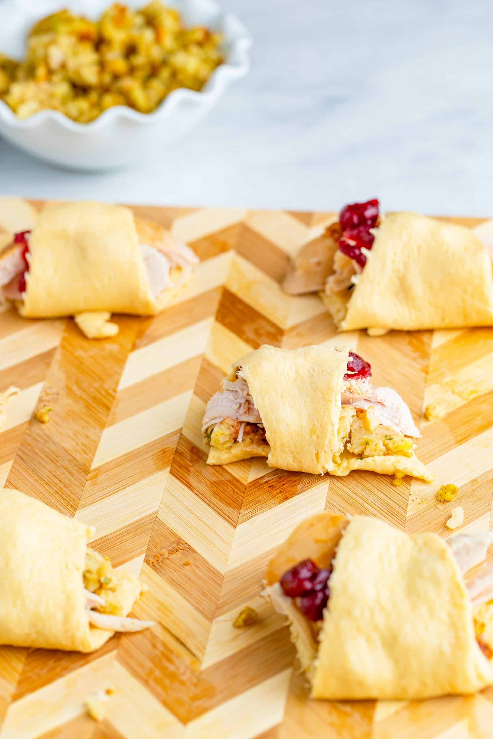 crescent roll bundles filled with sliced leftover turkey, turkey stuffing and whole cranberry sauce.