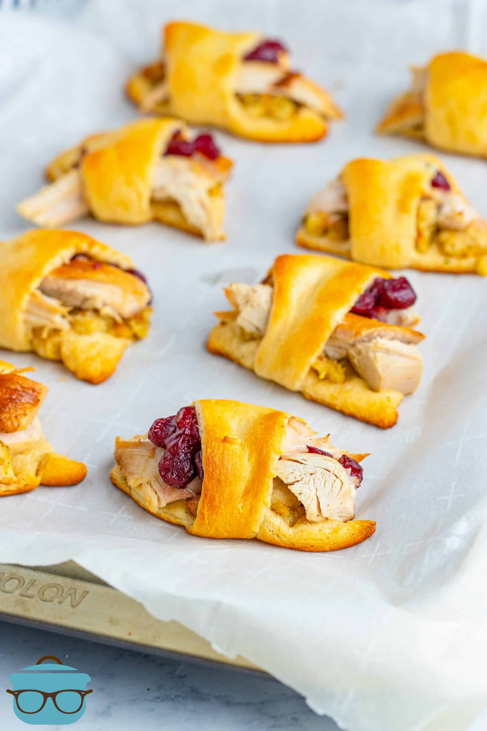 Leftover Turkey Crescent Roll Ups shown fully baked on parchment paper.