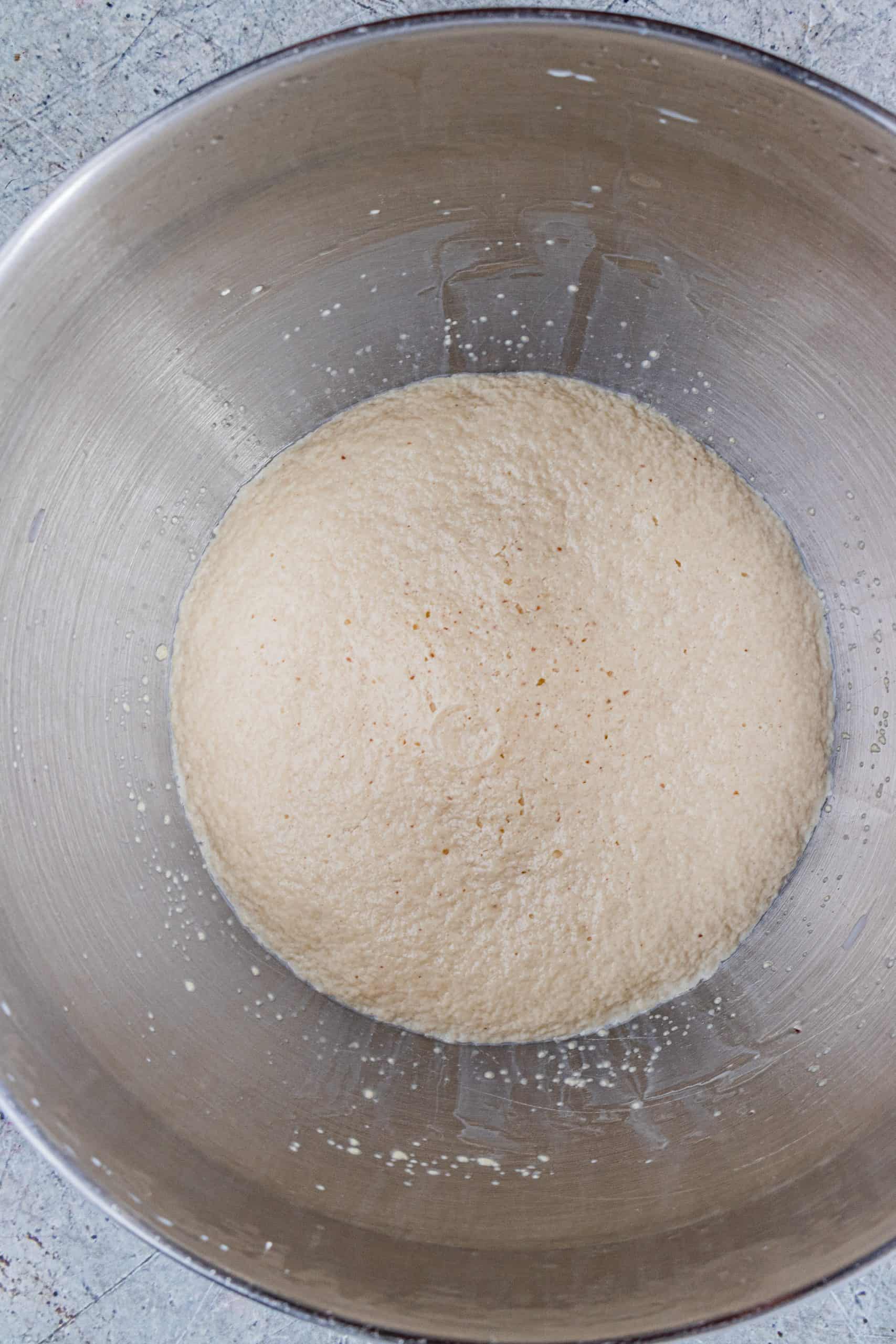 proofing yeast in the steel bowl of a stand mixer