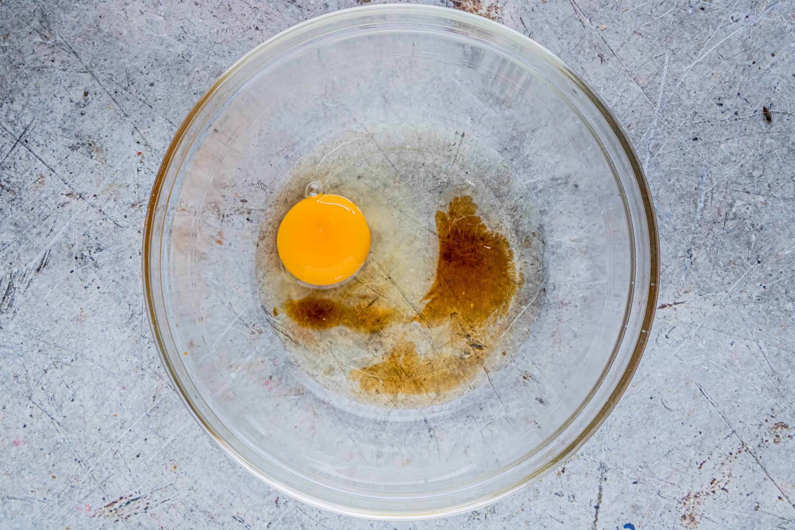 egg, corn syrup and vanilla extract in a clear glass bowl