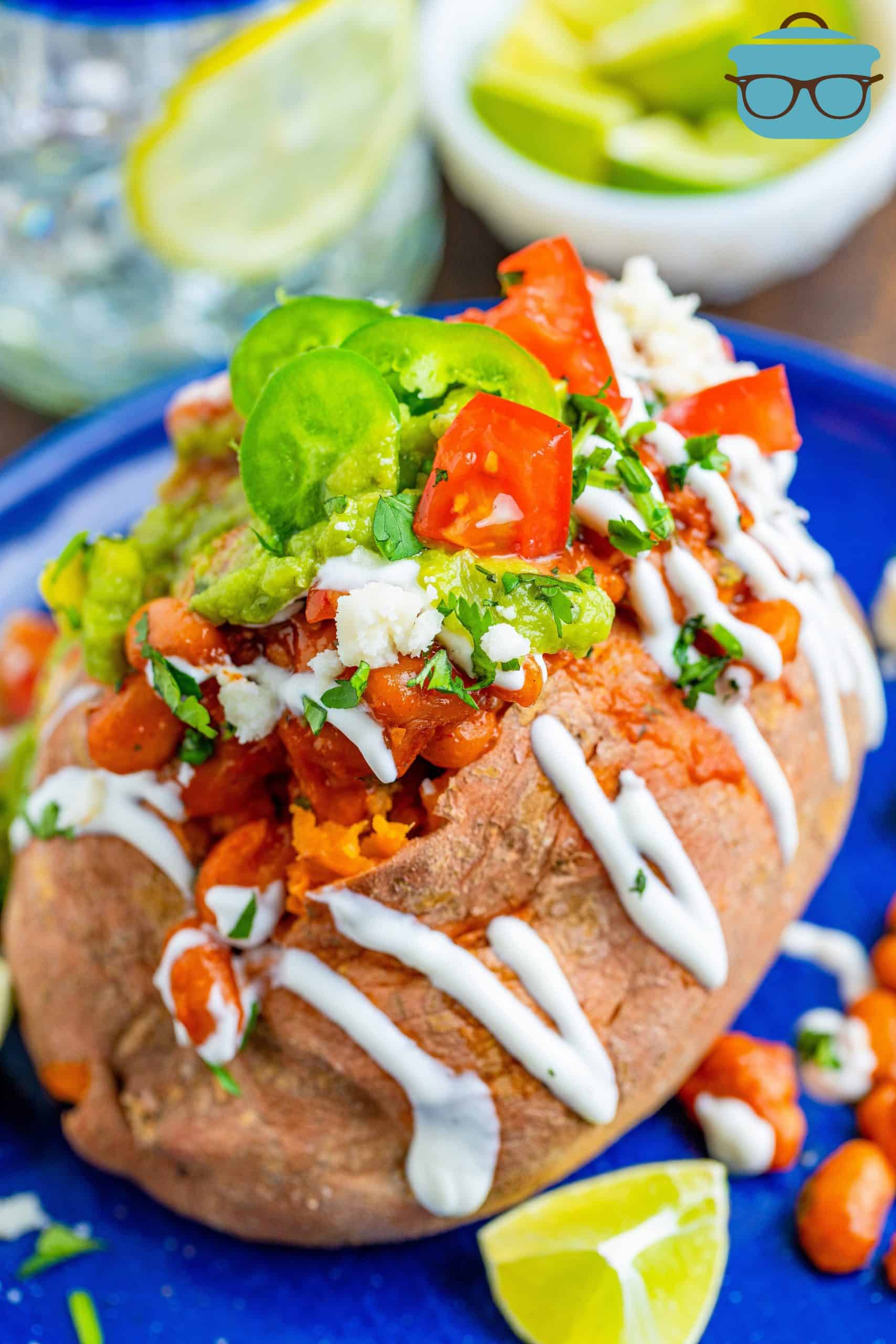 bean stuffed sweet potatoes topped with sour cream, guacamole, diced tomatoes and guacamole.