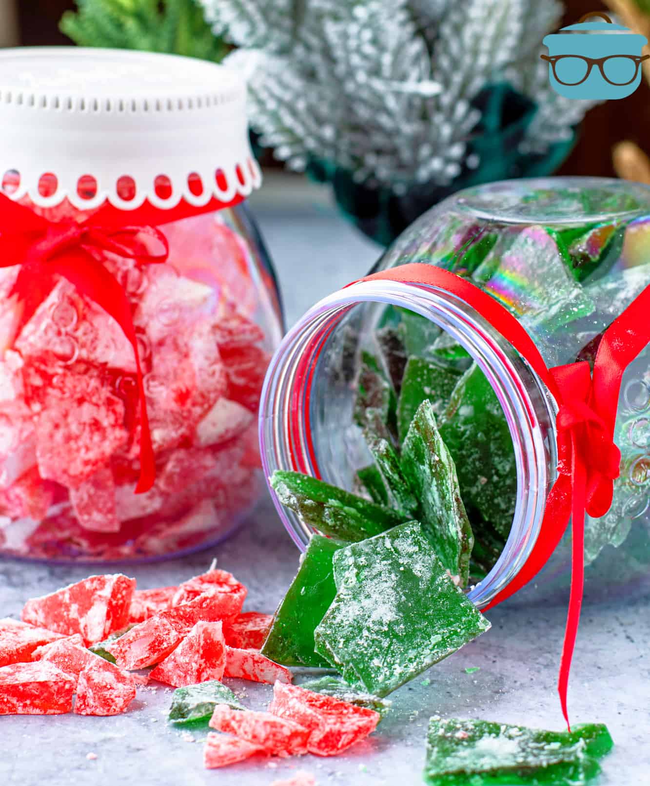 pieces of red and green cinnamon candy shown in glass containers.