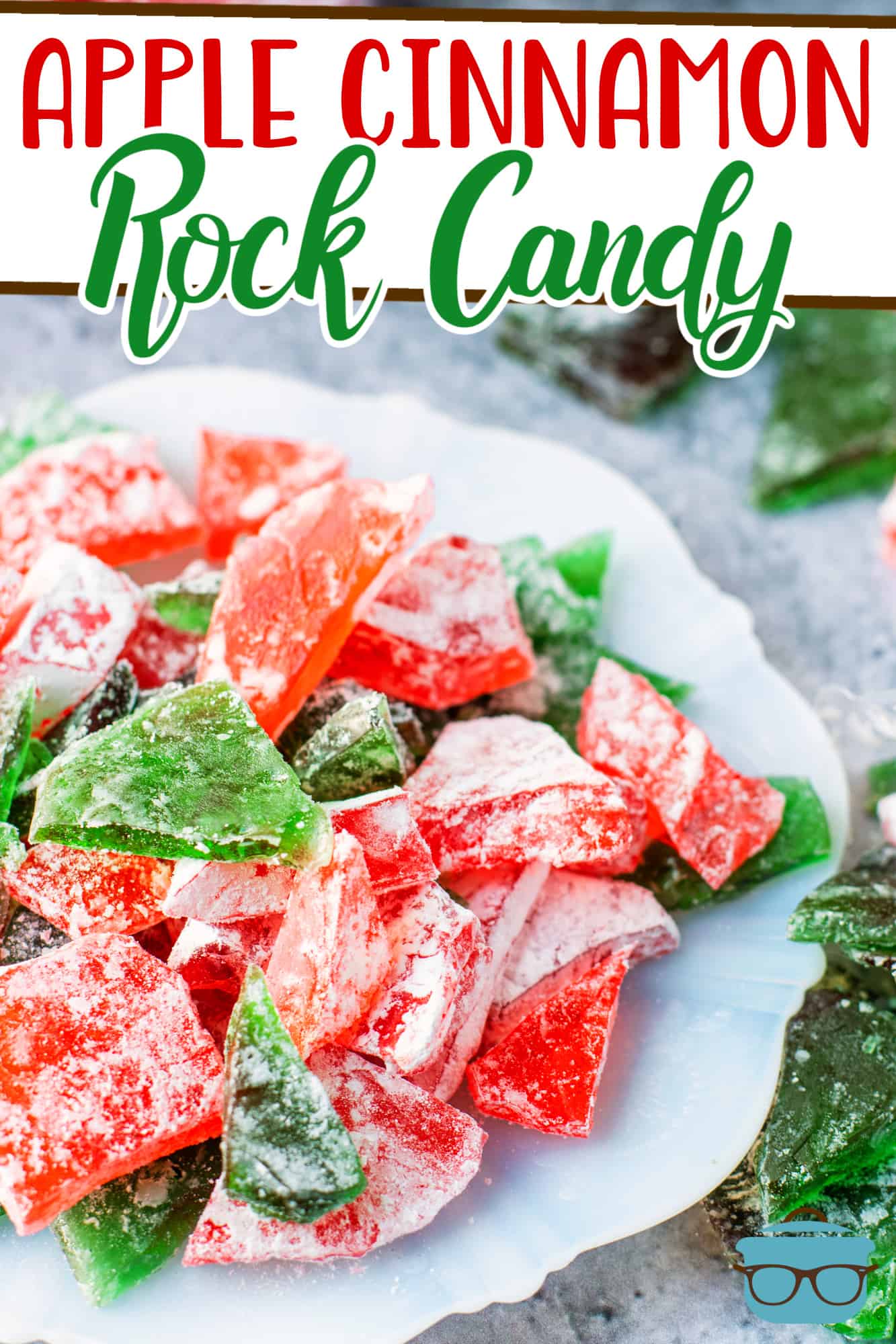 Apple Cinnamon Rock Candy recipe from The Country Cook, red and green pieces of rock candy shown on a white plate.