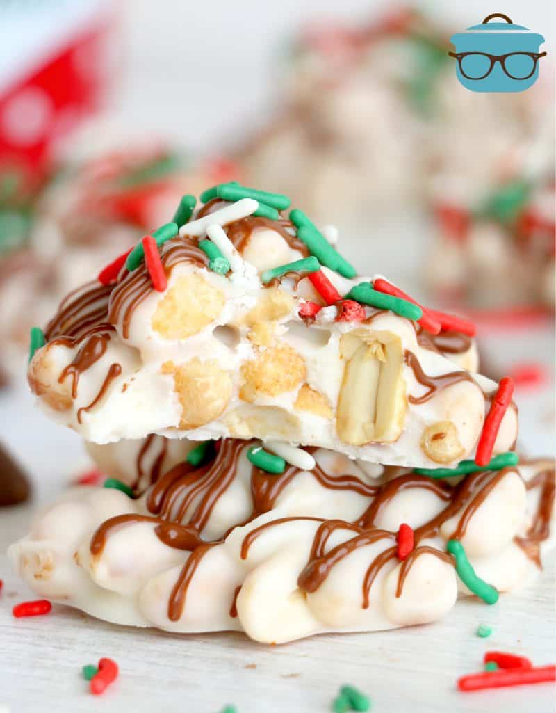 two white chocolate peanut clusters stacked on top of each other.