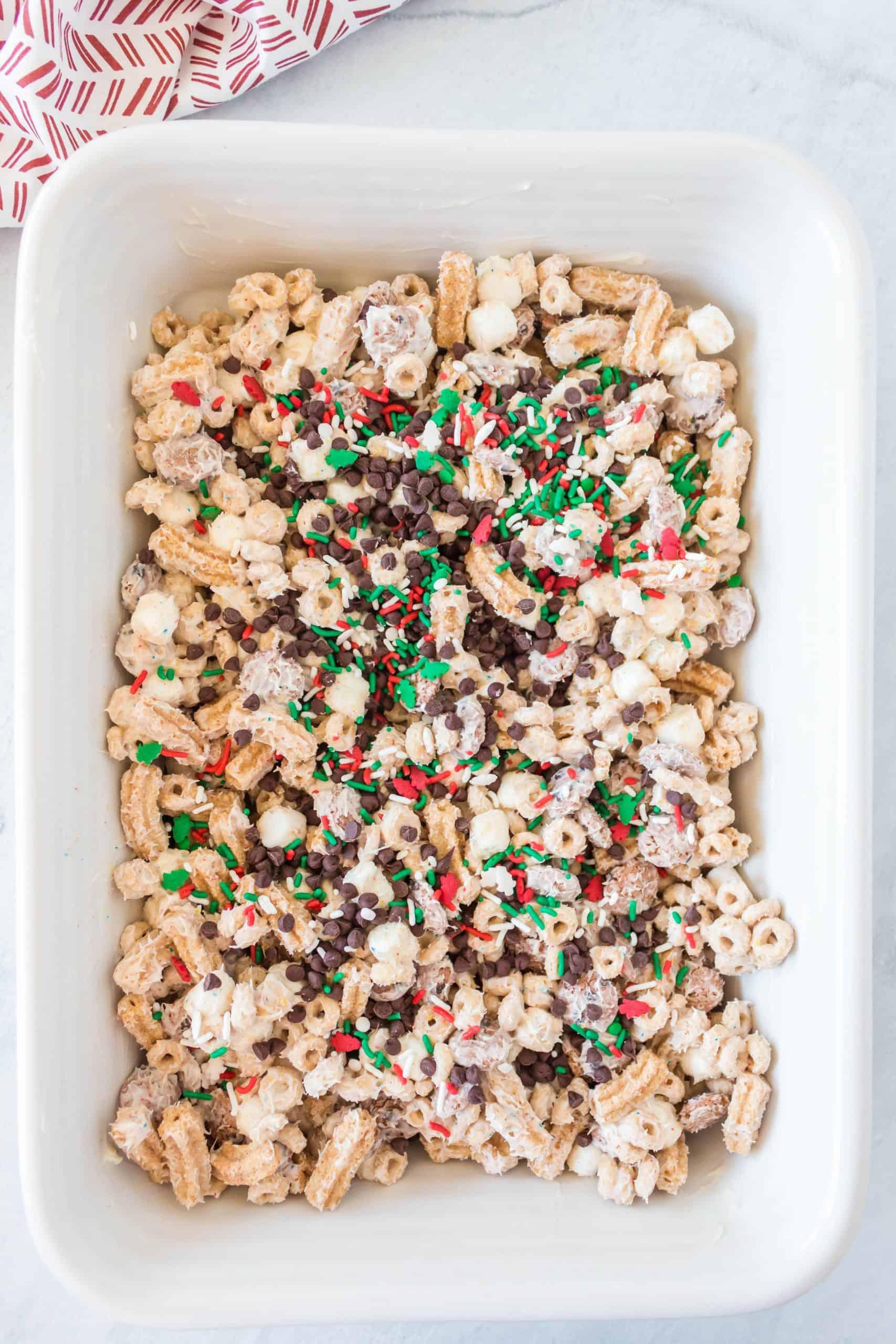 sprinkles and mini chocolate chips added to the top of chocolate cereal mixture.