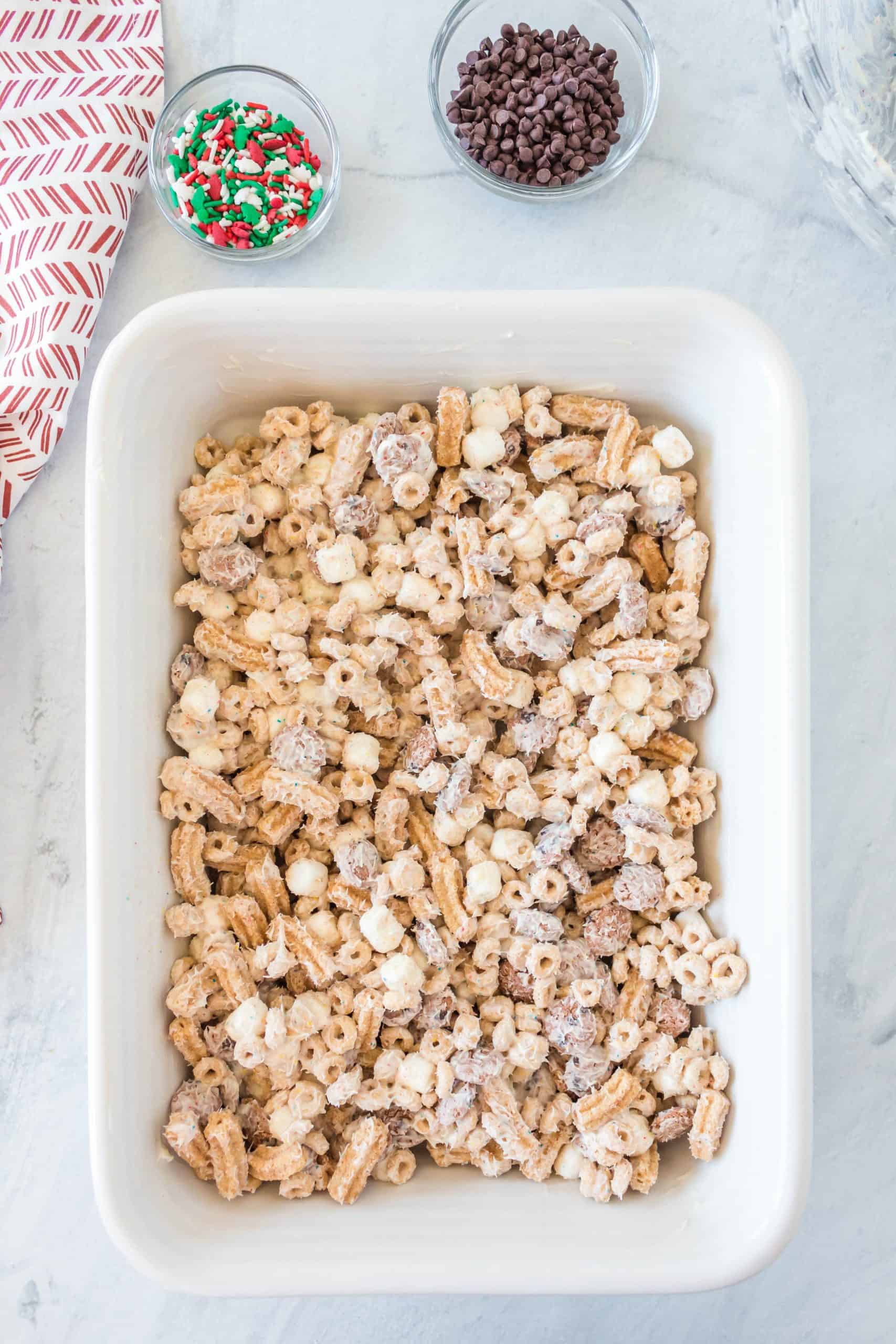 candy coated cereal spread into a greased baking dish.