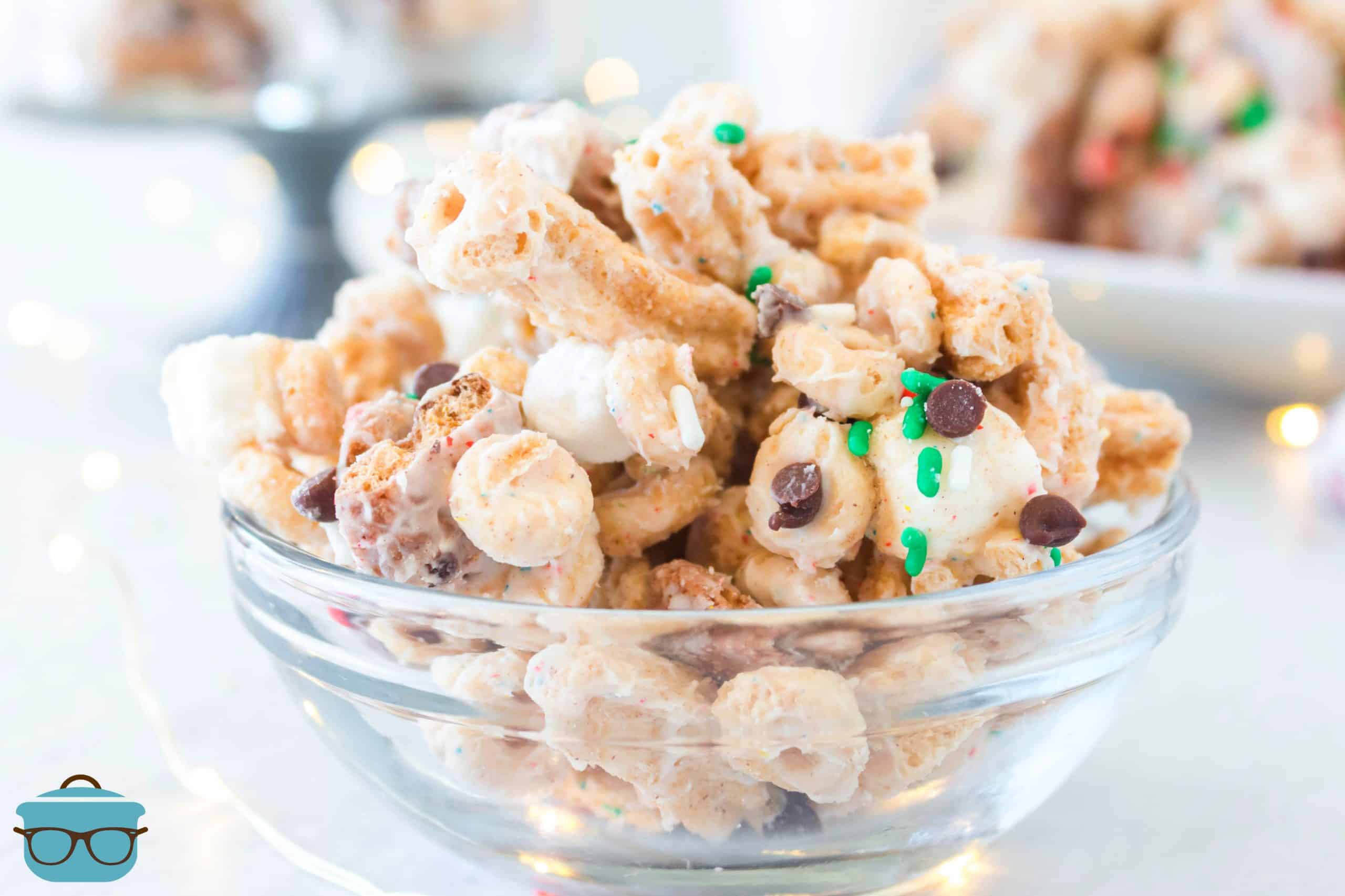 Elf Bait Snack Mix made with cereal with white chocolate in a small clear glass bowl.