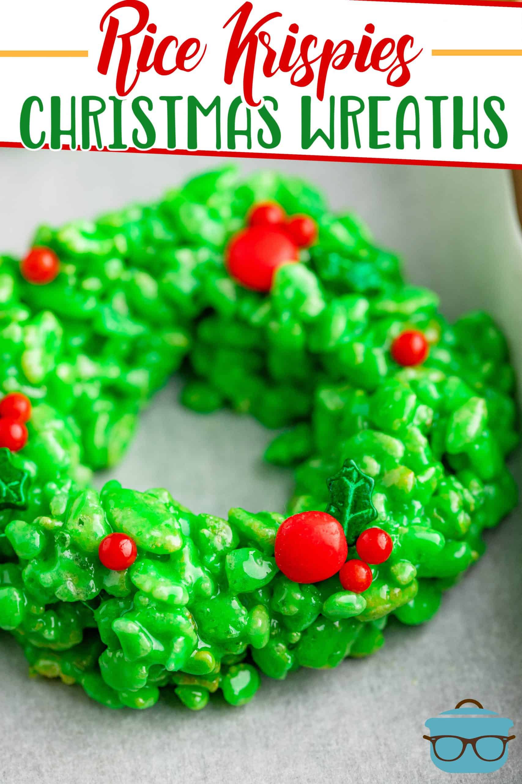 Rice Krispies Christmas Wreath recipe from The Country Cook, closeup of green Rice Krispies treats wreath that has red hot candies placed on top.