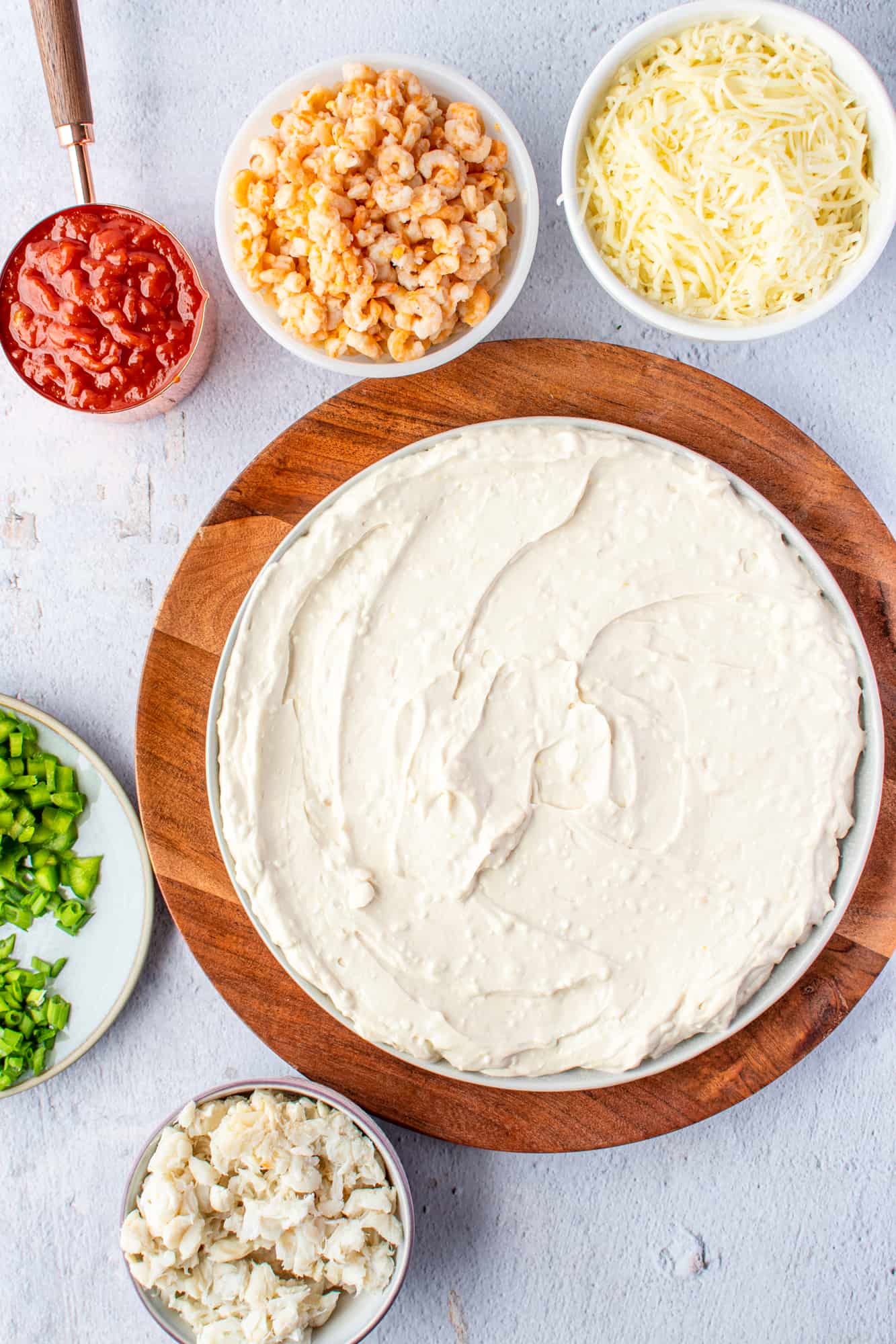 cream cheese mixture spread onto a large white serving platter.