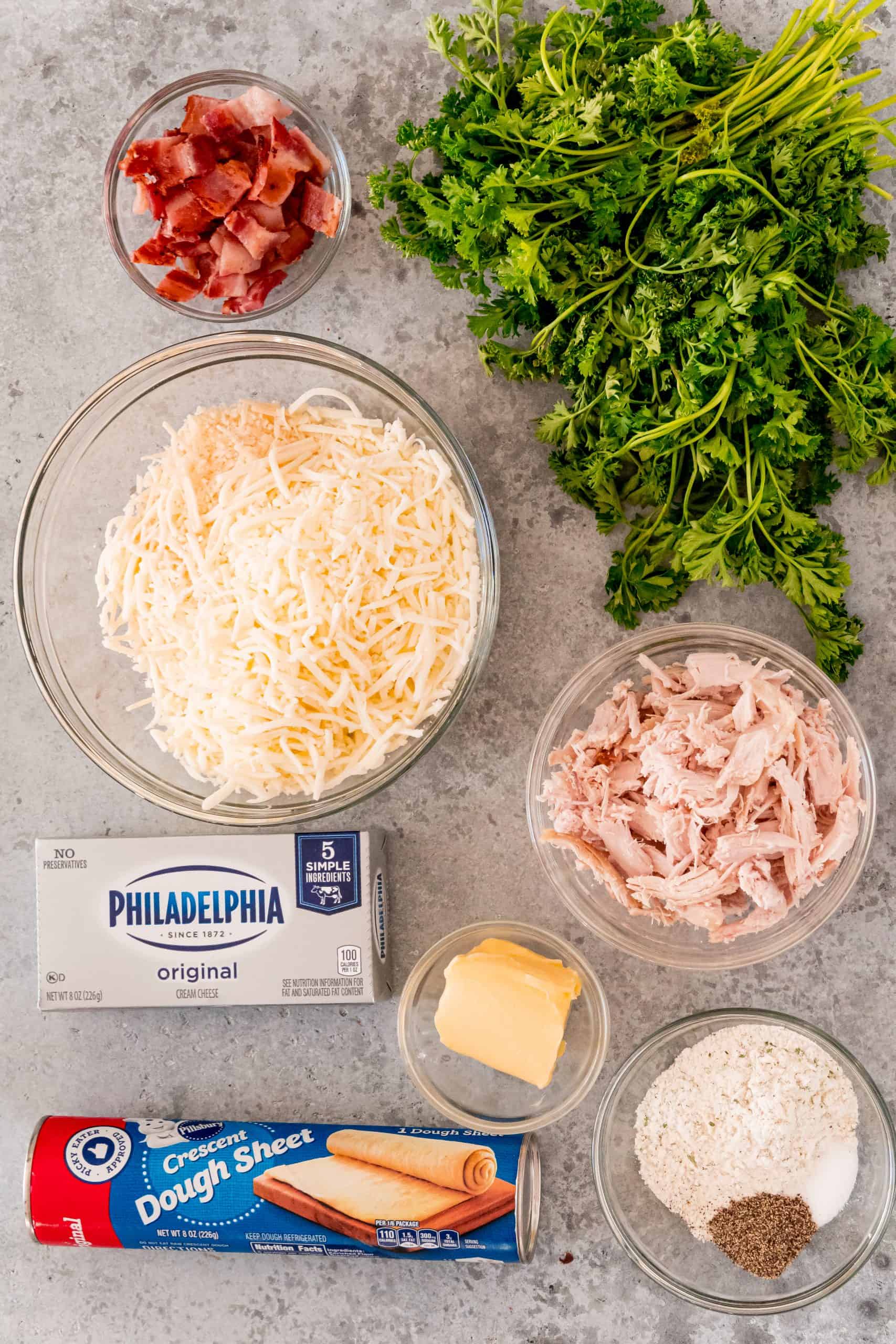 Ingredients Needed to make Crack Chicken Ball: crescent roll sheet, diced chicken, cooked bacon, cream cheese, mozzarella cheese, Parmesan cheese, ranch seasoning, butter and parsley.