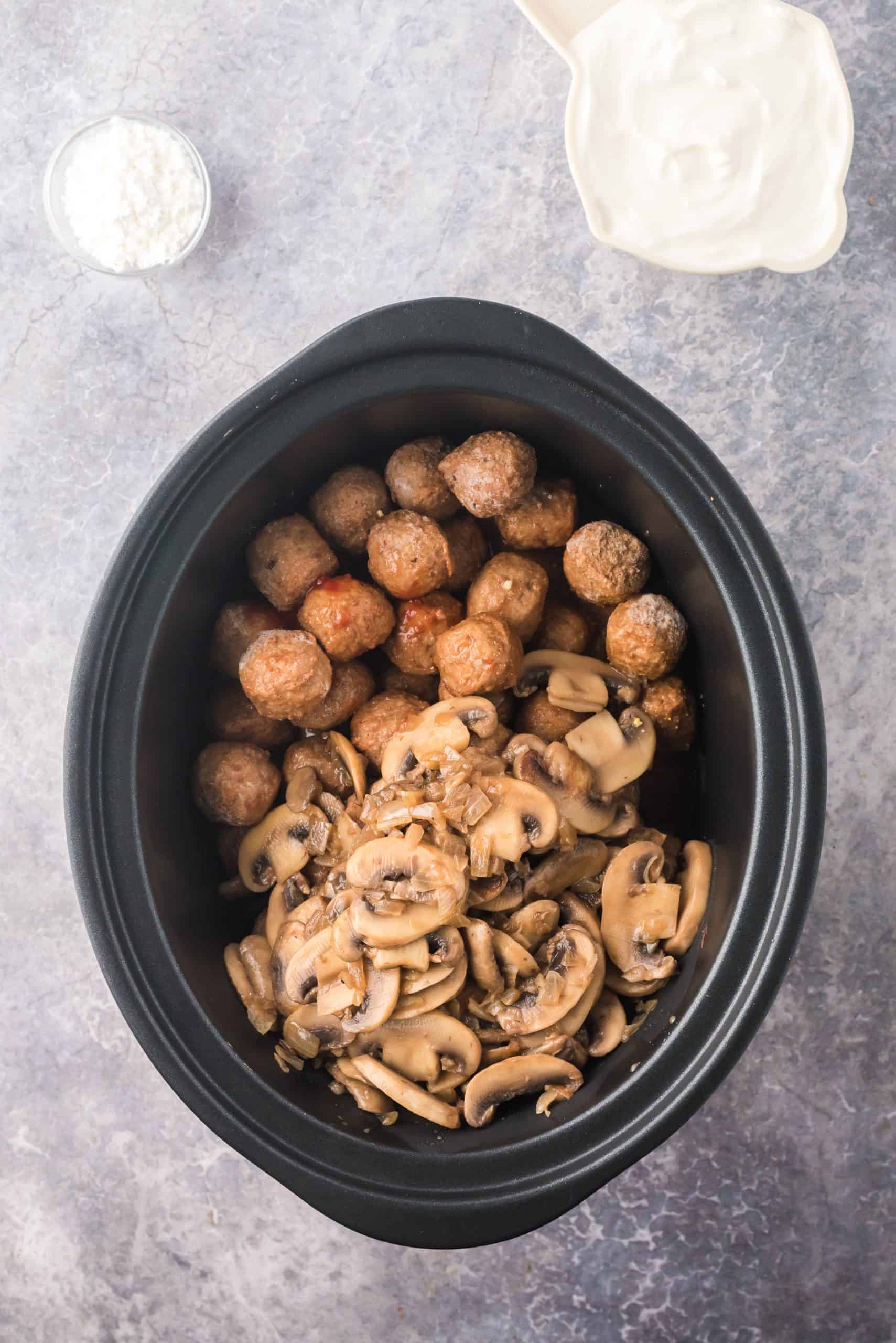 Frozen meatballs and mushroom and onion mixture added to crock pot