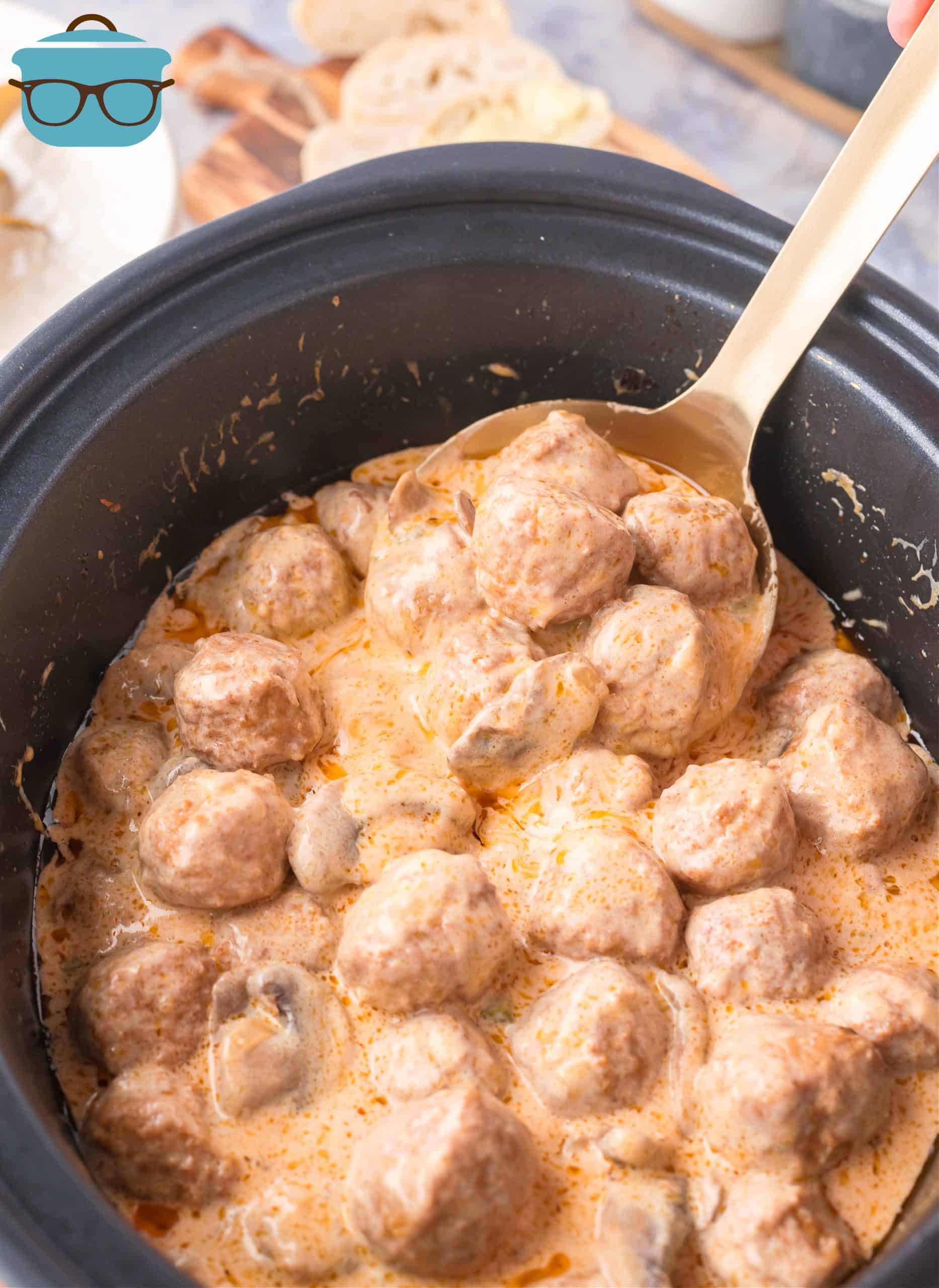 Finished Crock Pot Meatball Stroganoff in Crock Pot with spoon