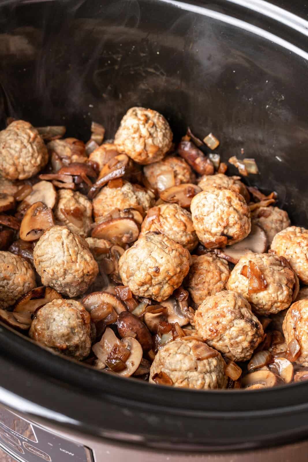 frozen meatballs with onions and mushrooms in the slow cooker. 