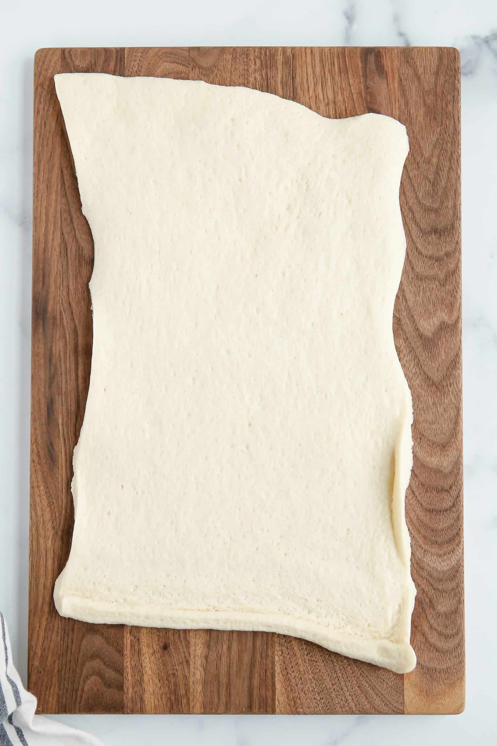 Rolled out dough on cutting board.