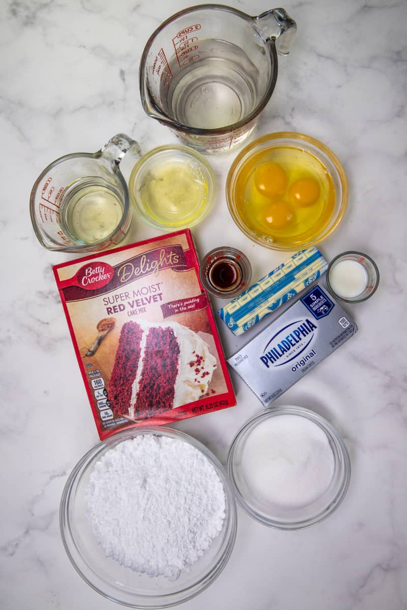 red Velvet Cheesecake Cake ingredients: red velvet cake mix, eggs, oil, water, cream cheese, butter, powdered sugar, vanilla extract, milk.