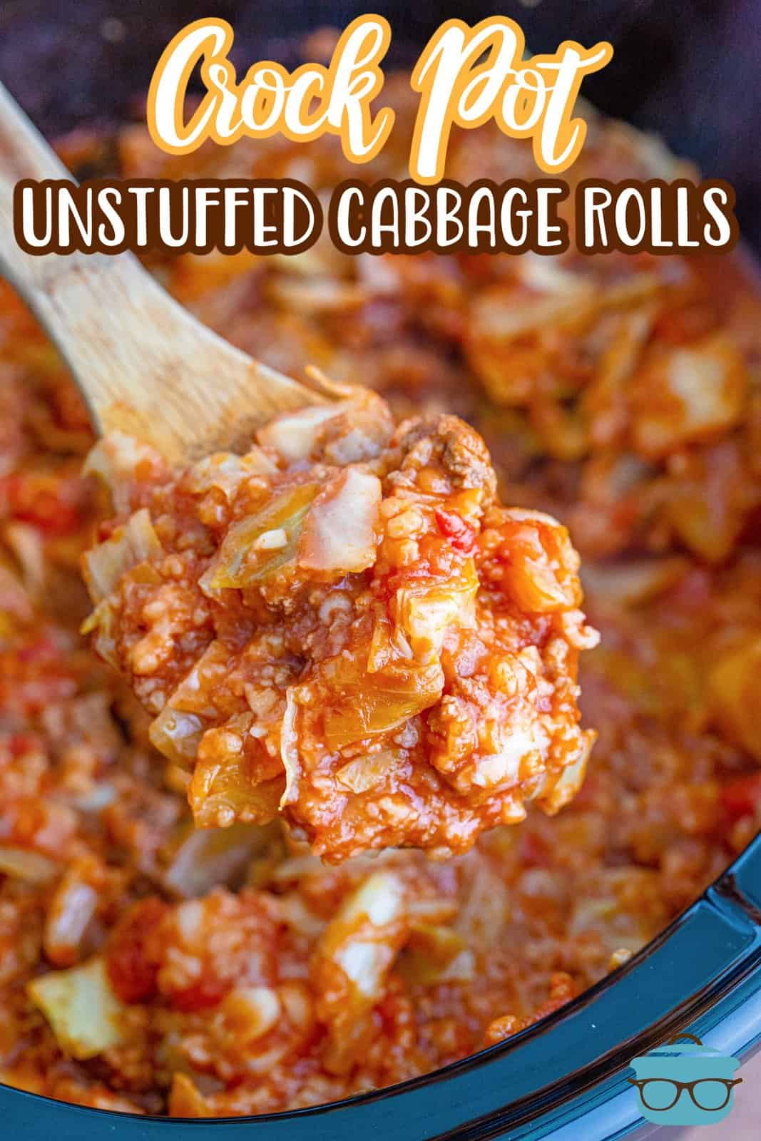 a wooden spoon holding up a serving of unstuffed cabbage rolls over an oval slow cooker.
