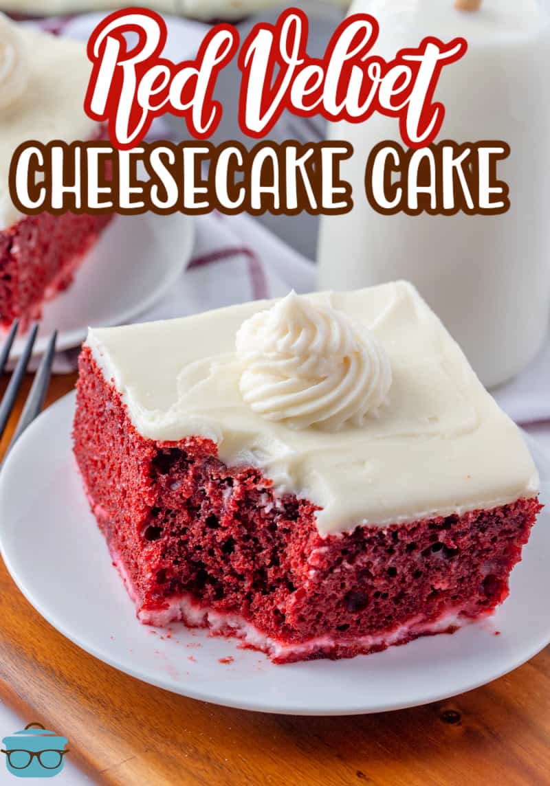 a slice of red velvet cheesecake cake on a small round white plate with a small piece removed. 