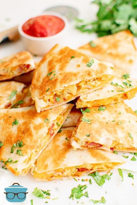 Stacked Breakfast Quesadillas with dipping sauce in background