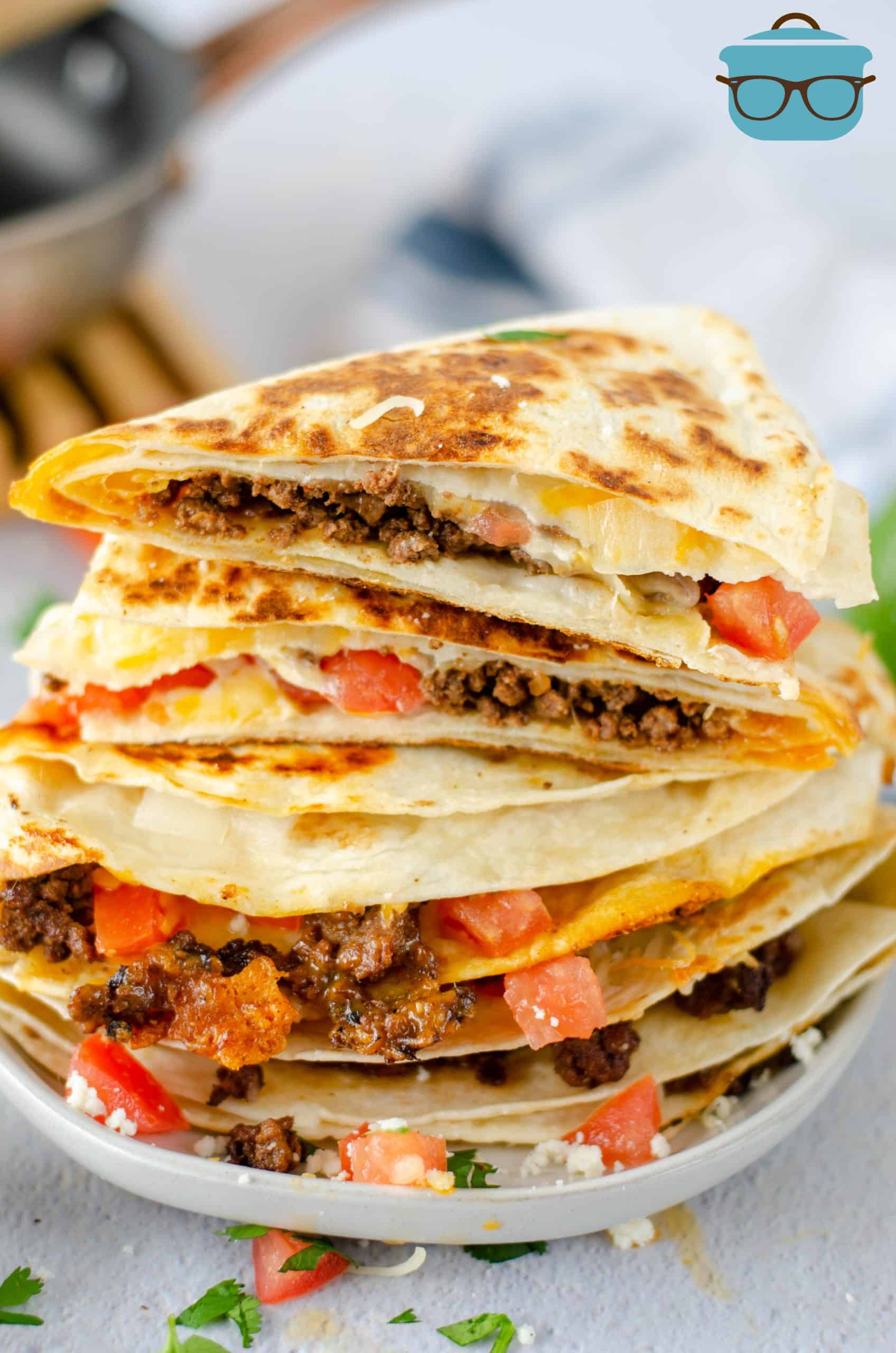 Stacked Taco Quesadillas cut open on white plate