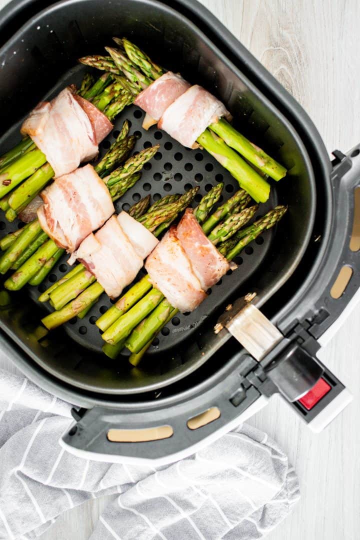 Bacon wrapped asparagus uncooked in air fryer.
