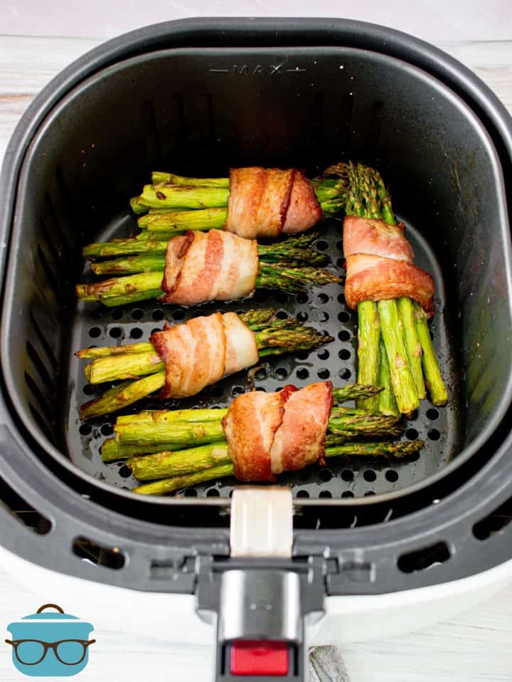 Finished Air Fryer Bacon Wrapped Asparagus in air fryer.