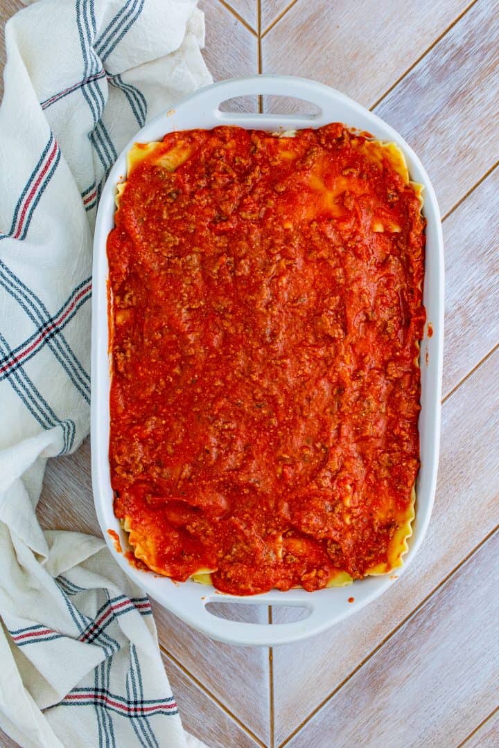 Meat sauce spread evenly on top of lasagna noodles.