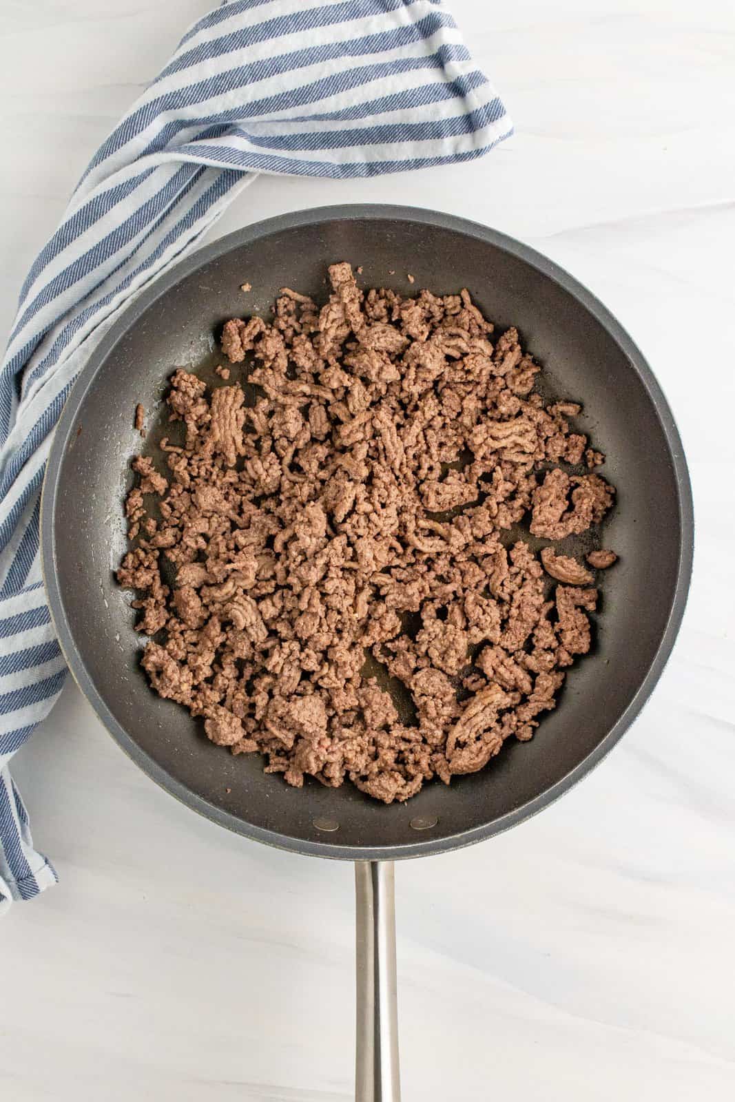 browned and crumbled cooked ground beef in a large skillet. 