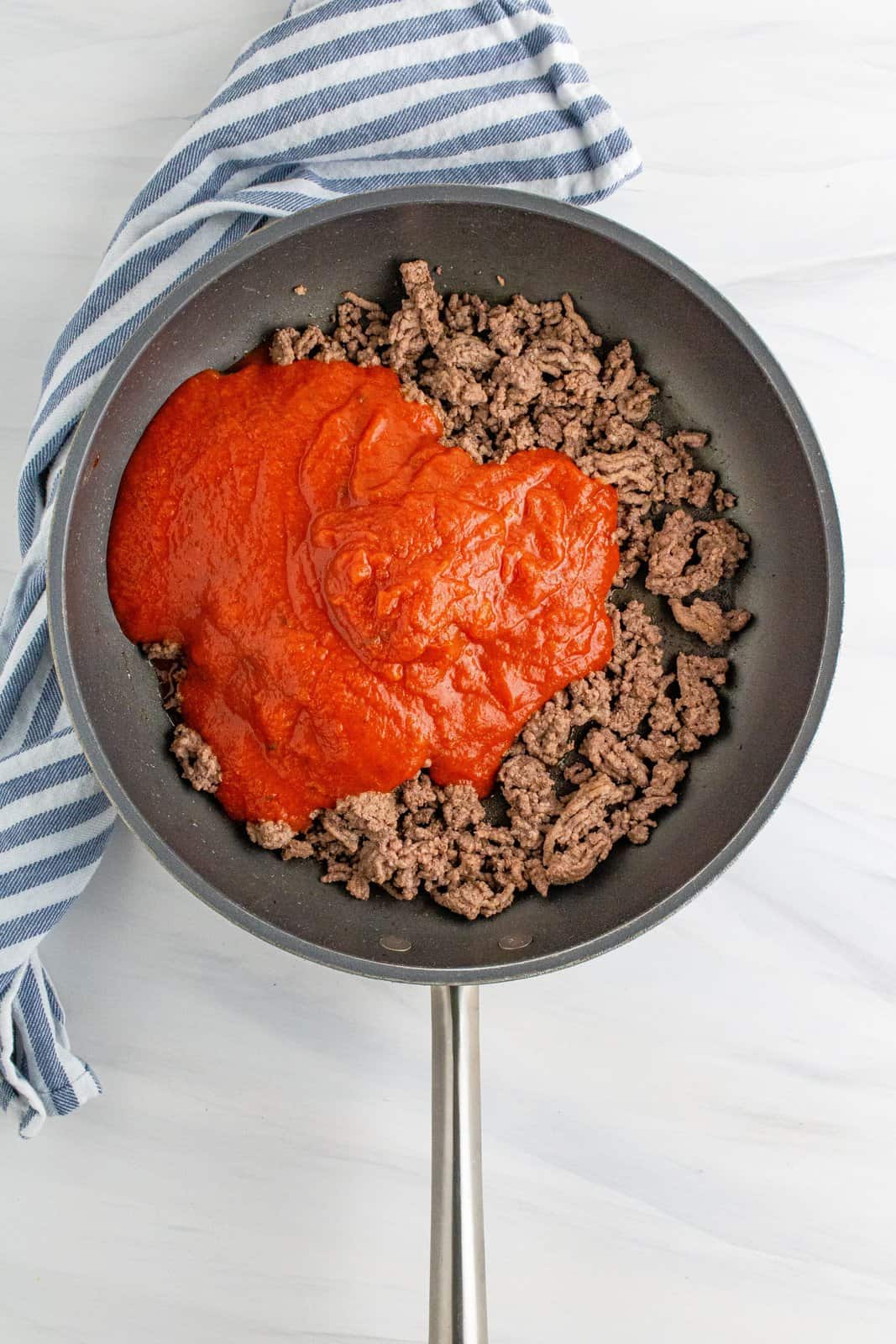 spaghetti sauce added to the ground beef in the large skillet. 