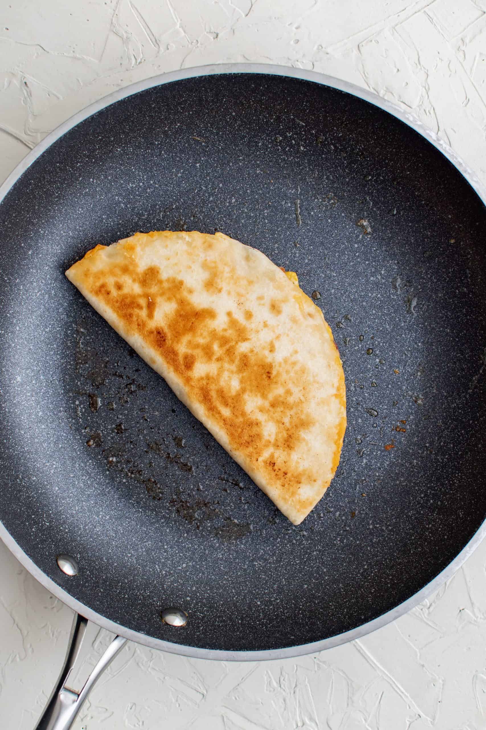 Browned finished quesadilla in pan.