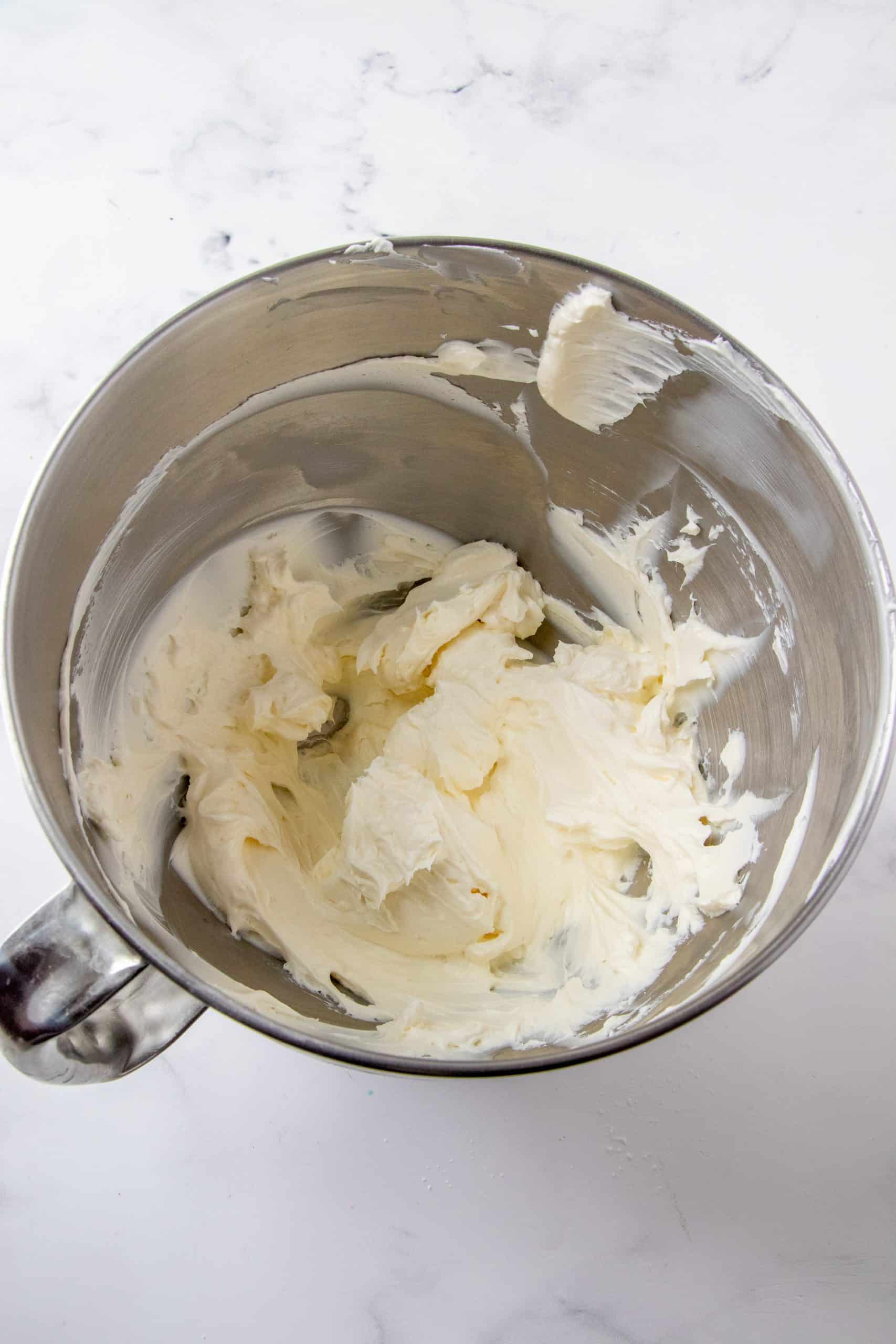 Cream Cheese shown smooth in the bowl of a stand mixer.