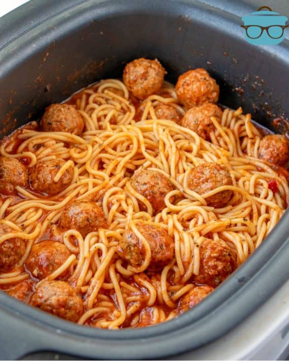 cooked spaghetti and meatballs shown in the slow cooker