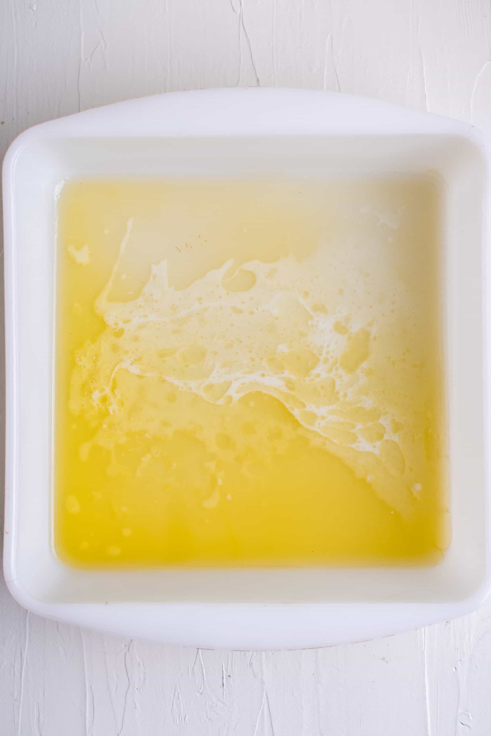 Melted butter in baking pan. 