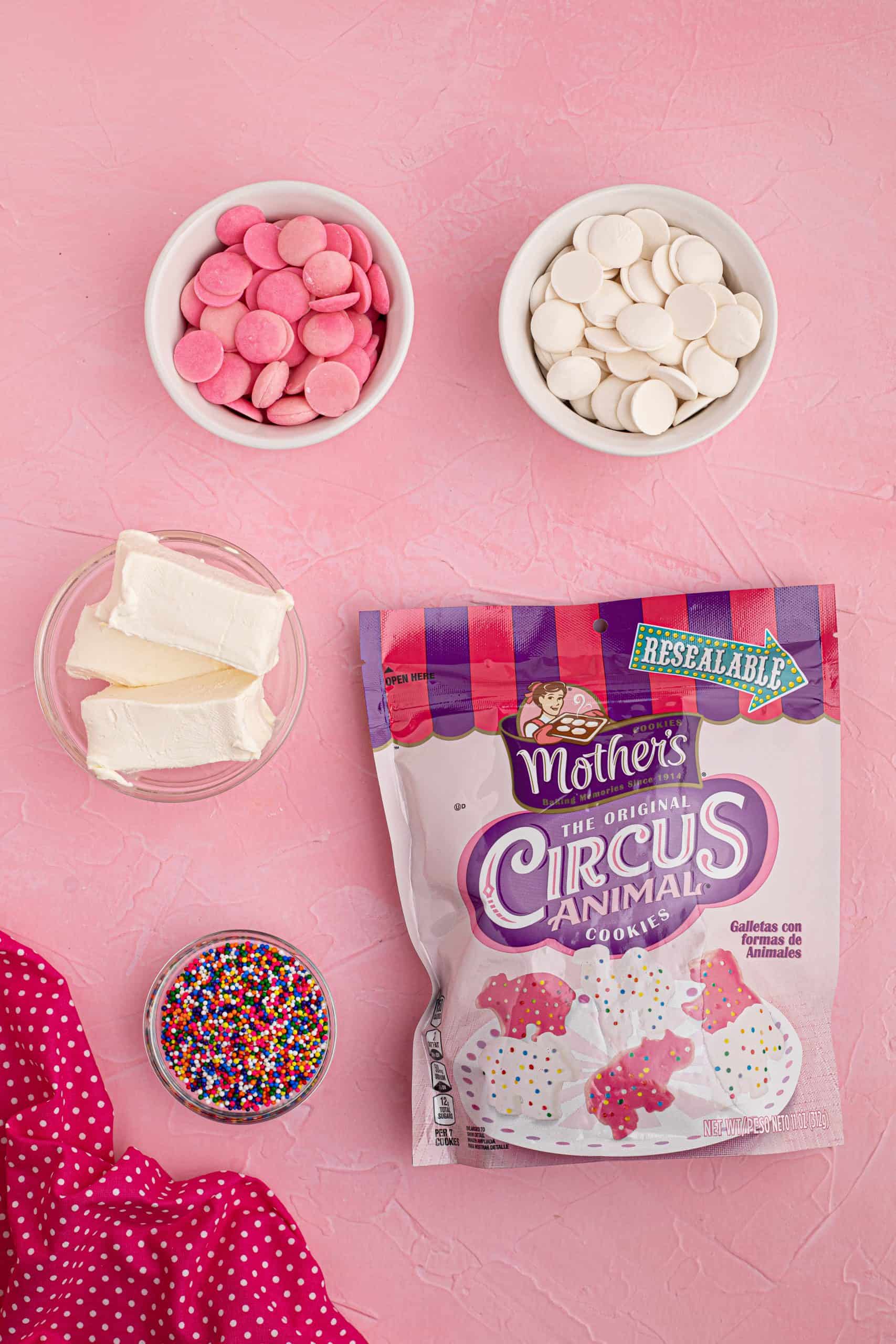 Ingredients needed to make Circus Animal Cookie Balls: CIRCUS ANIMAL COOKIES, PINK CANDY MELTS, WHITE CANDY MELTS, CREAM CHEESE.