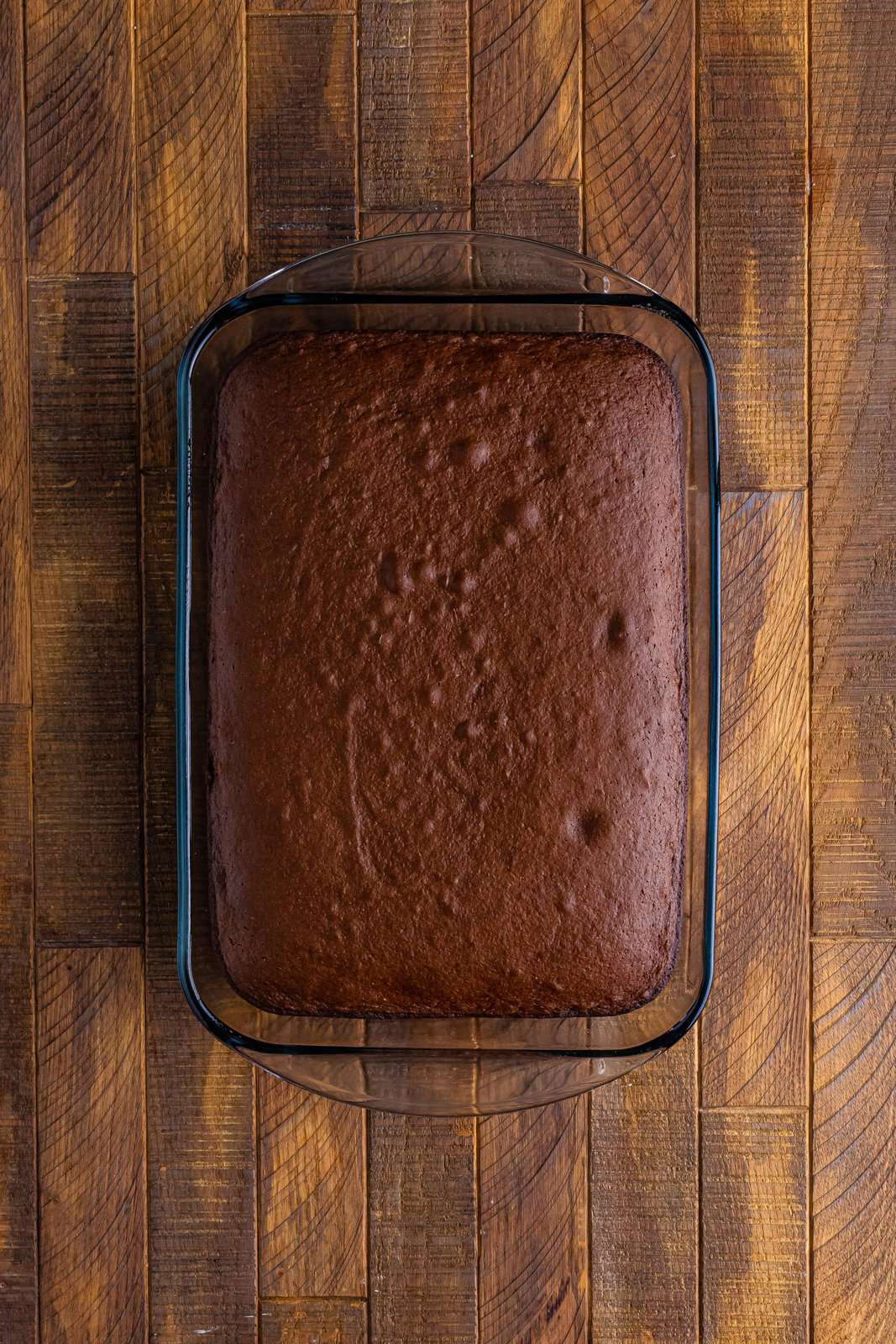 fully cooked chocolate cake in a clear baking dish.