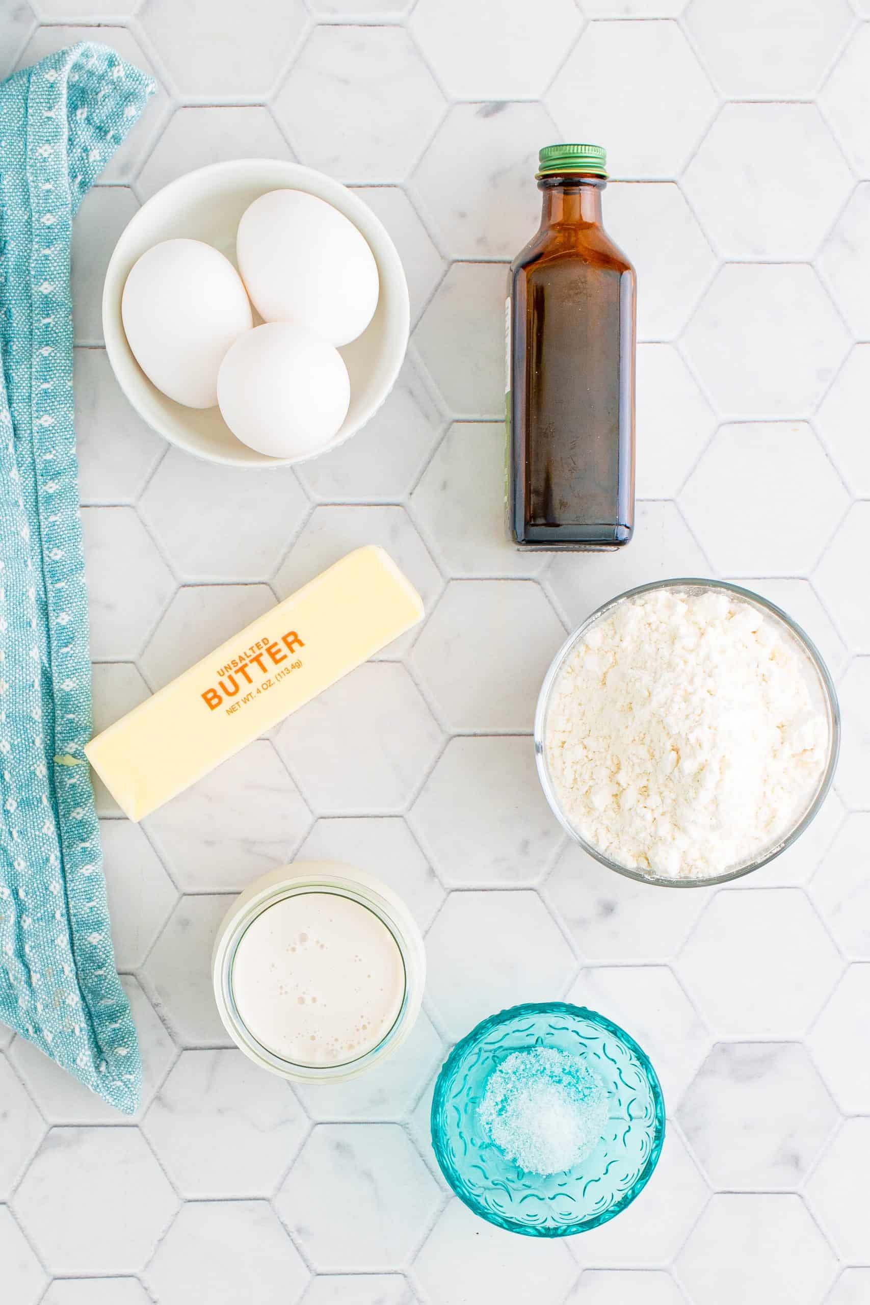 Ingredients needed to make a Dutch Baby Pancake: butter, eggs, flour, coffee creamer, vanilla extract and salt.
