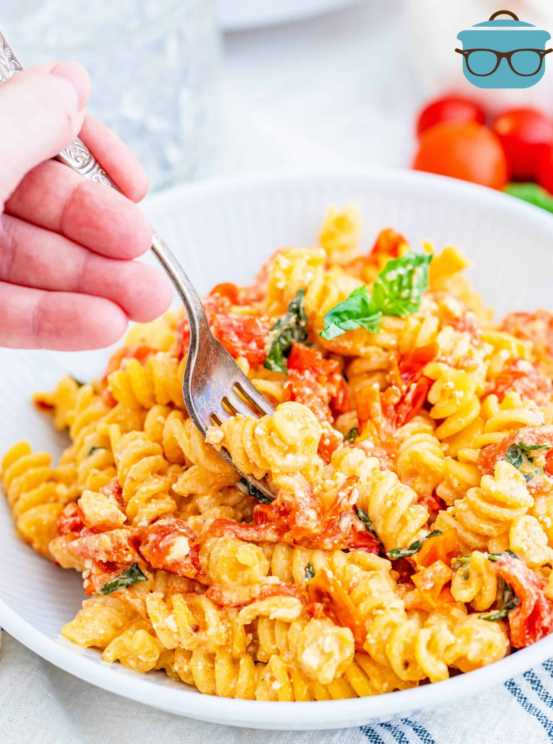 Feta Tomato Pasta in a white bowl with a fork.