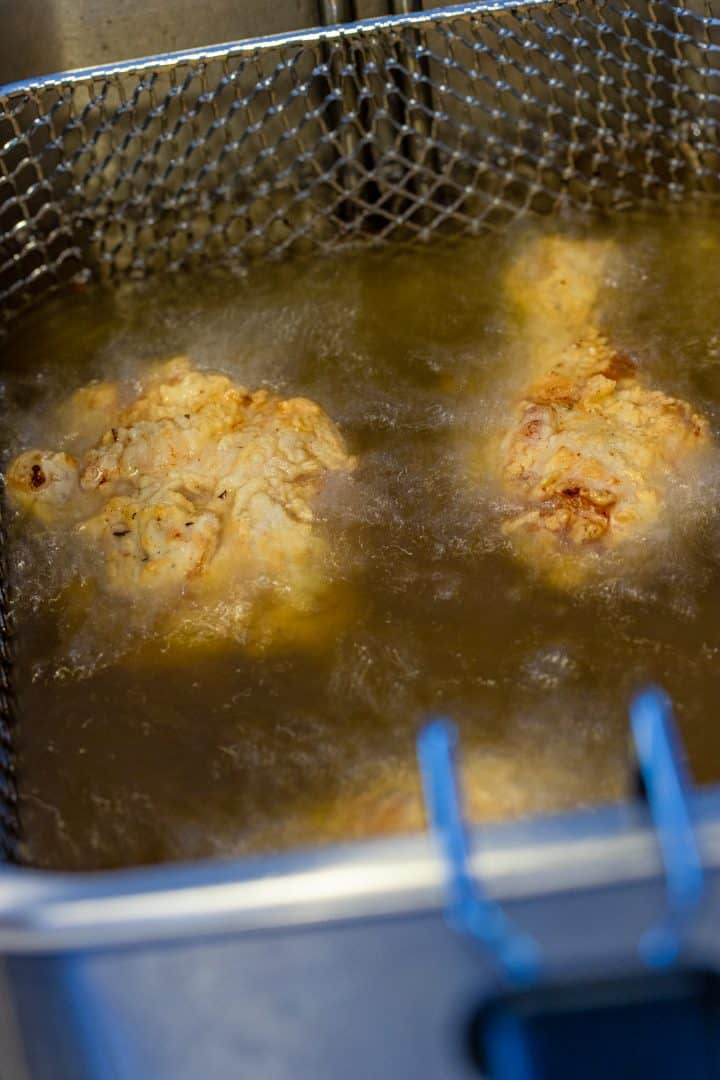 Chicken in frying oil.