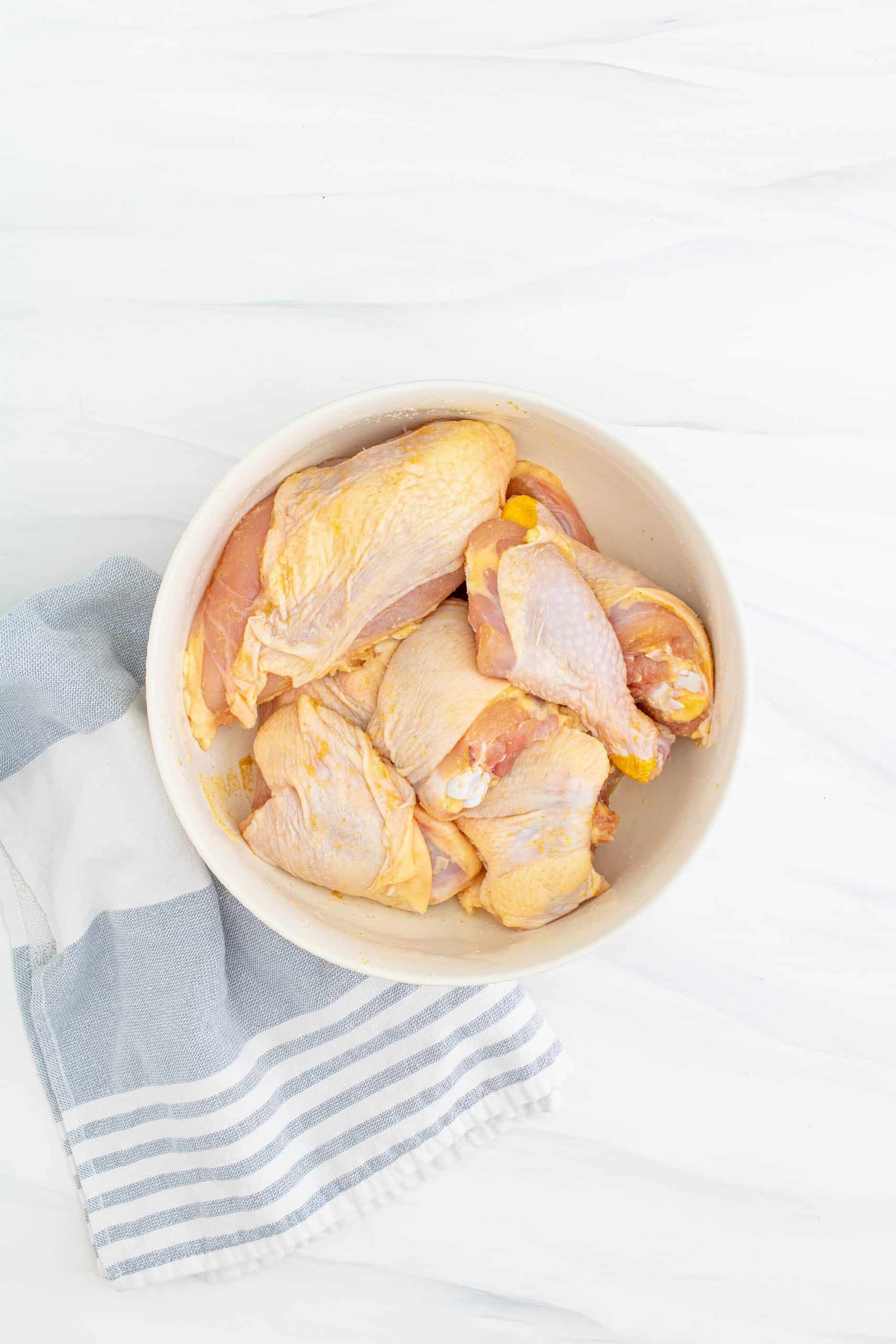 cut up chicken in a white bowl.