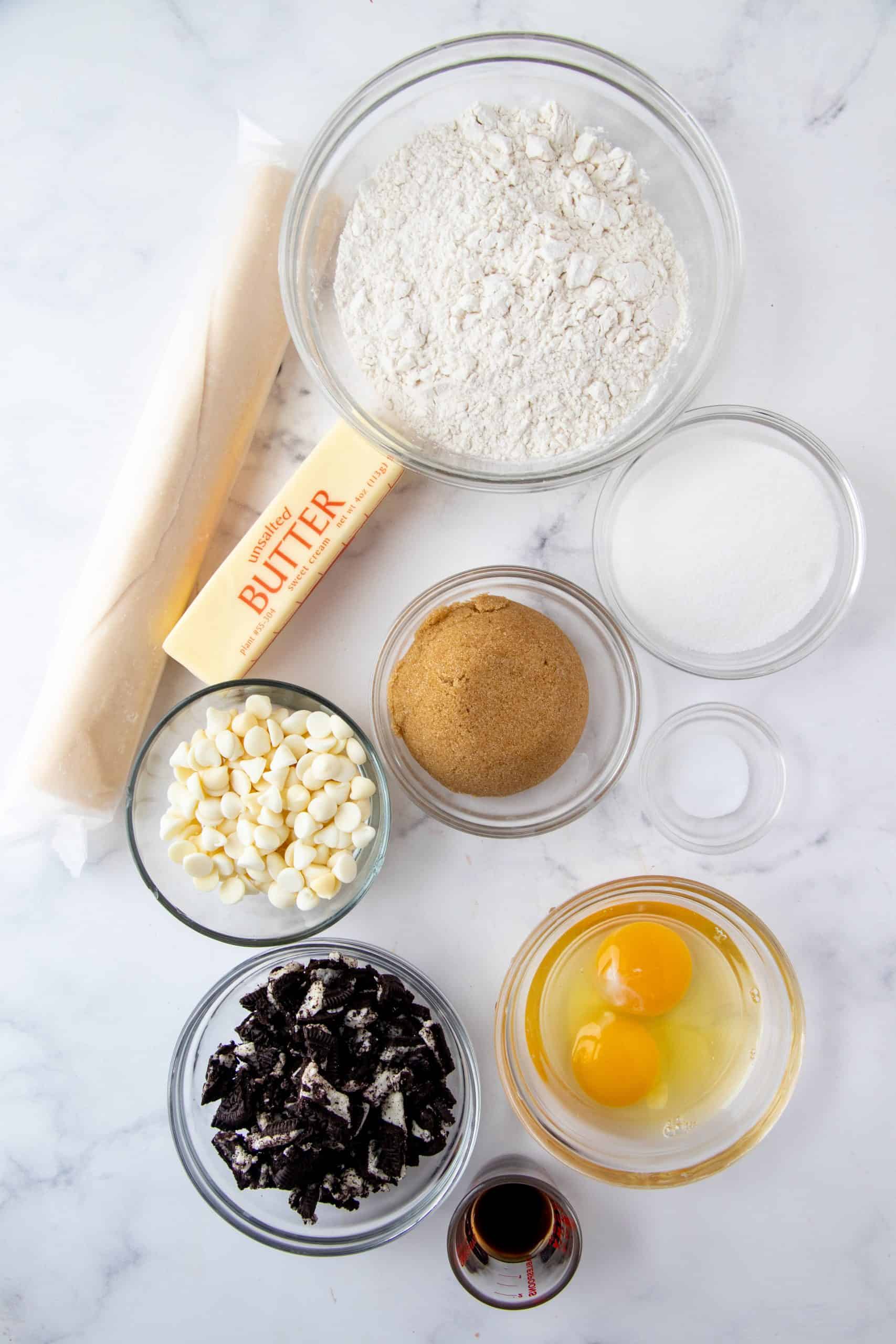 Ingredients needed to make Oreo Cookie Pie: refrigerated pie crust, unsalted butter, brown sugar, granulated sugar, eggs, vanilla extract, salt, all-purpose flour, Oreo cookies, white chocolate chips.