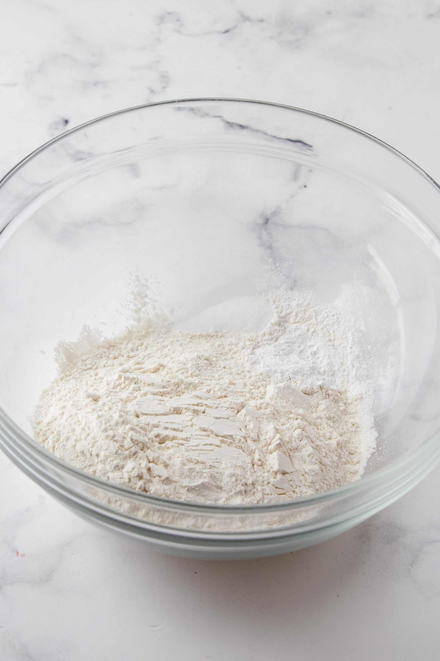Flour, baking powder and salt in bowl.