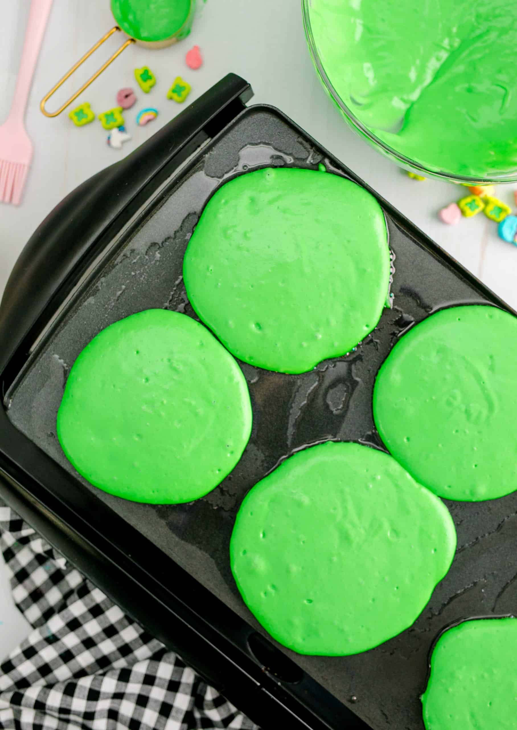 Green Pancakes on griddle.